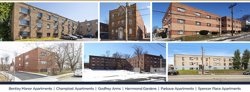 Tall modern skyscraper with vertical lines, viewed against a clear blue sky.