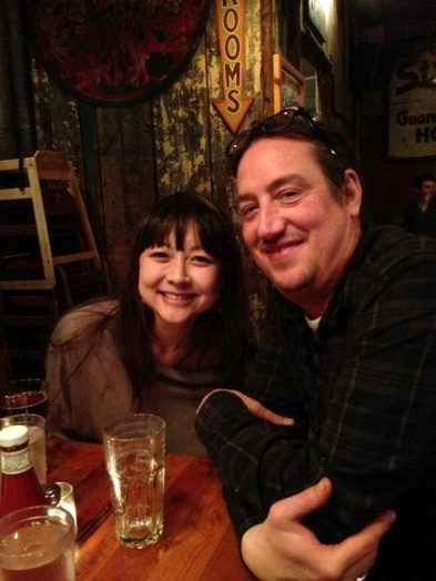 A photo of two persons sitting at a restaurant table.