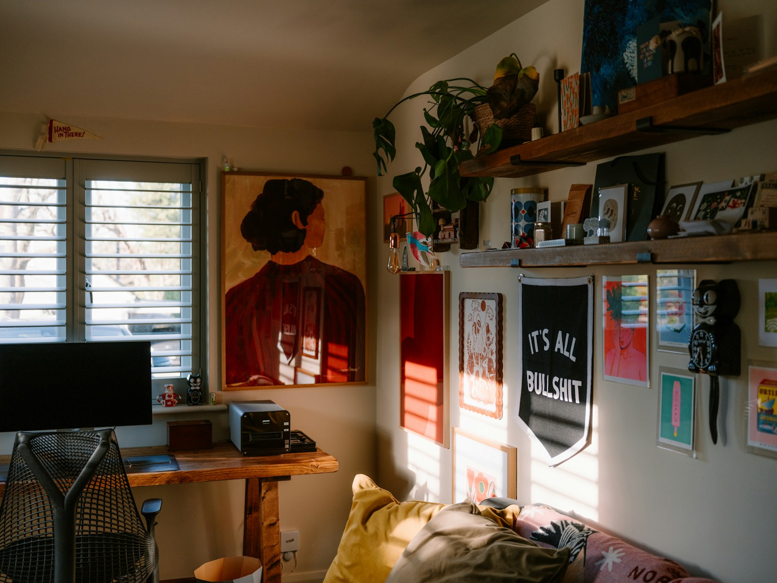 Sunlit creative room with art plants and desk
