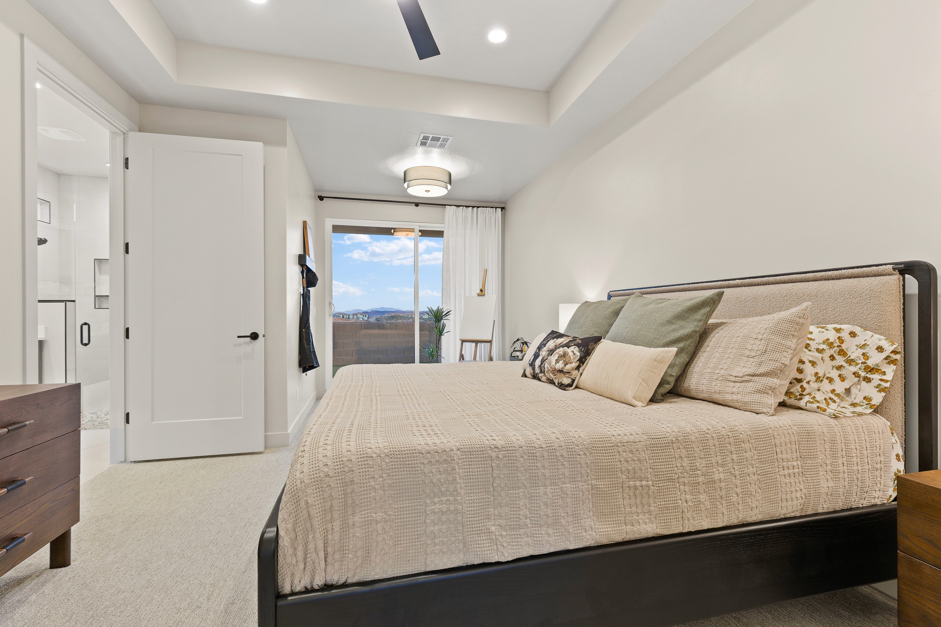 Primary bedroom inside The Painted Horizon twin home in Hurricane, Utah featuring a spacious layout and natural light.