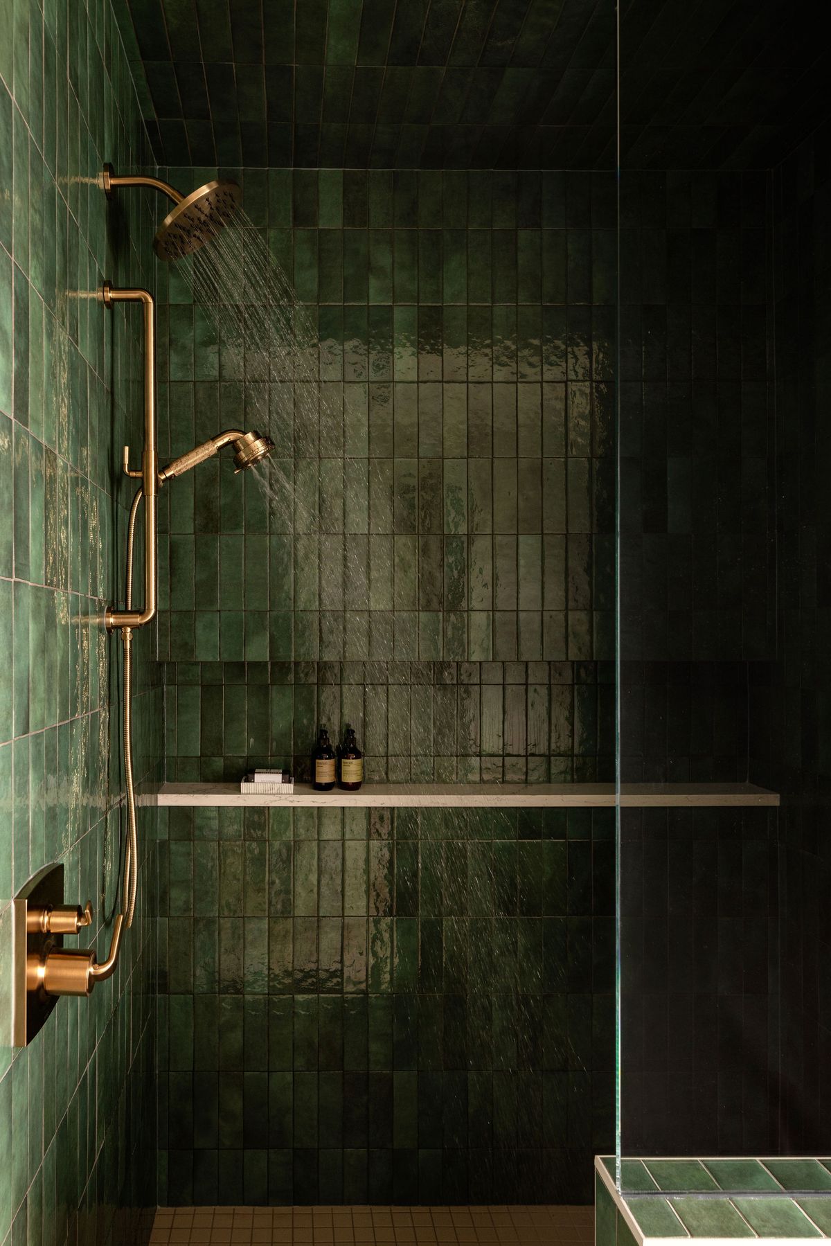 Floating white track shoe with bright orange accents and metal spikes, presented in a clean studio environment with a soft shadow.