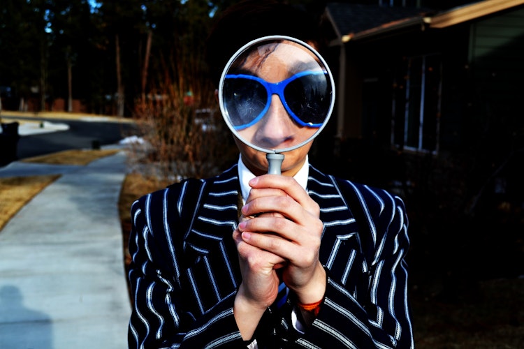 A man looking through a magnifying glass