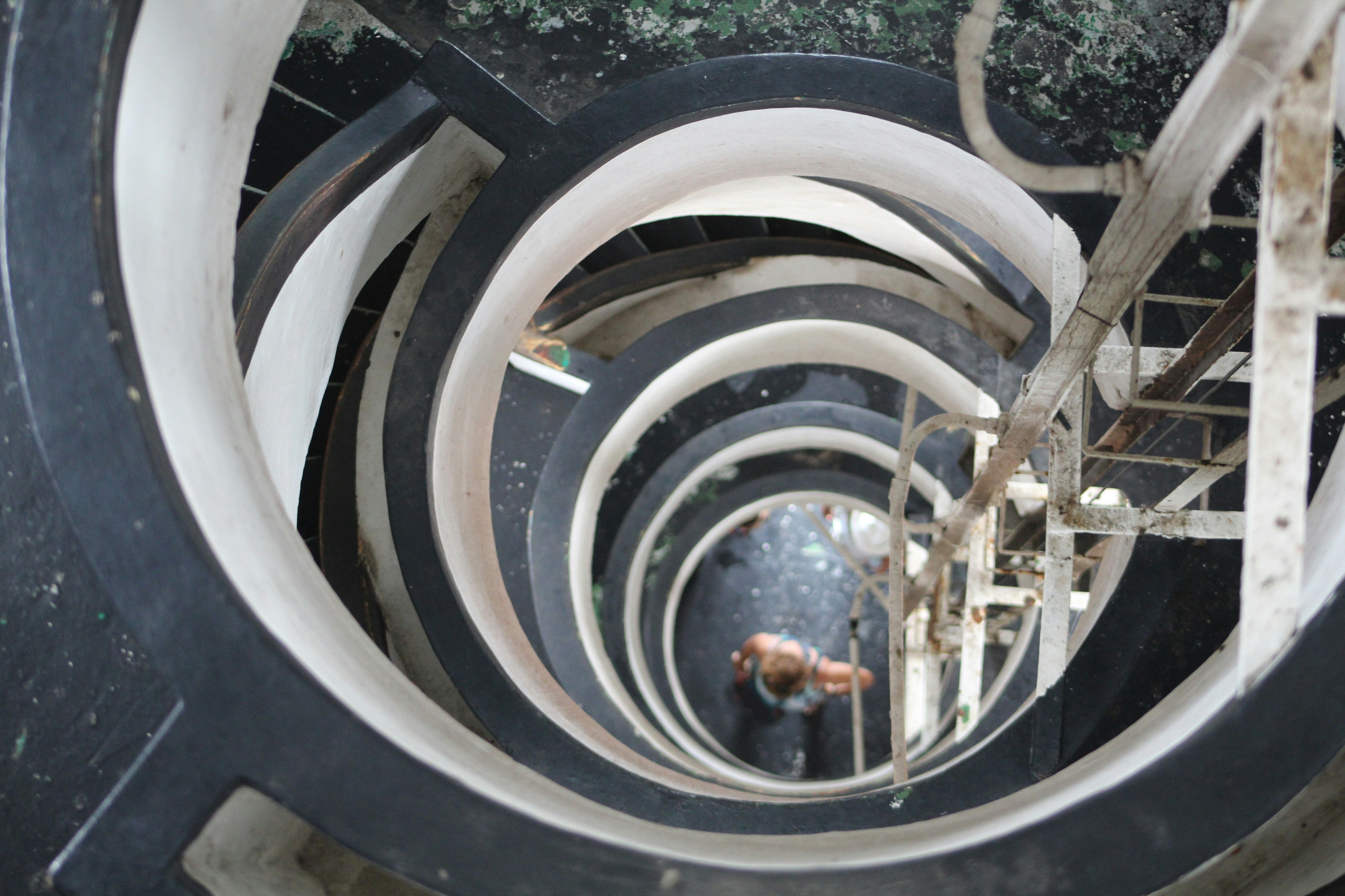 brown spiral staircase with black metal railings