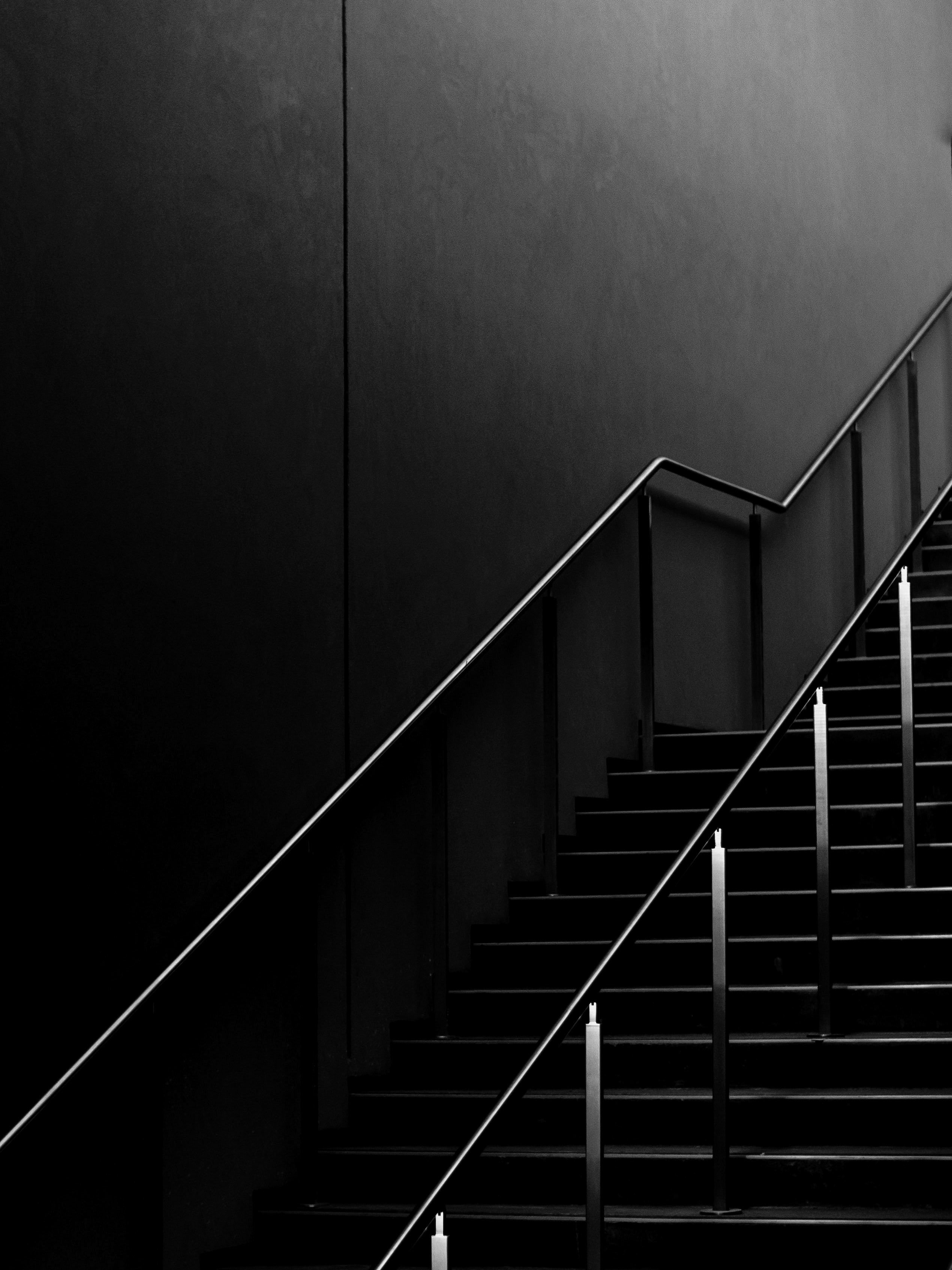 grayscale photo of staircase with railings