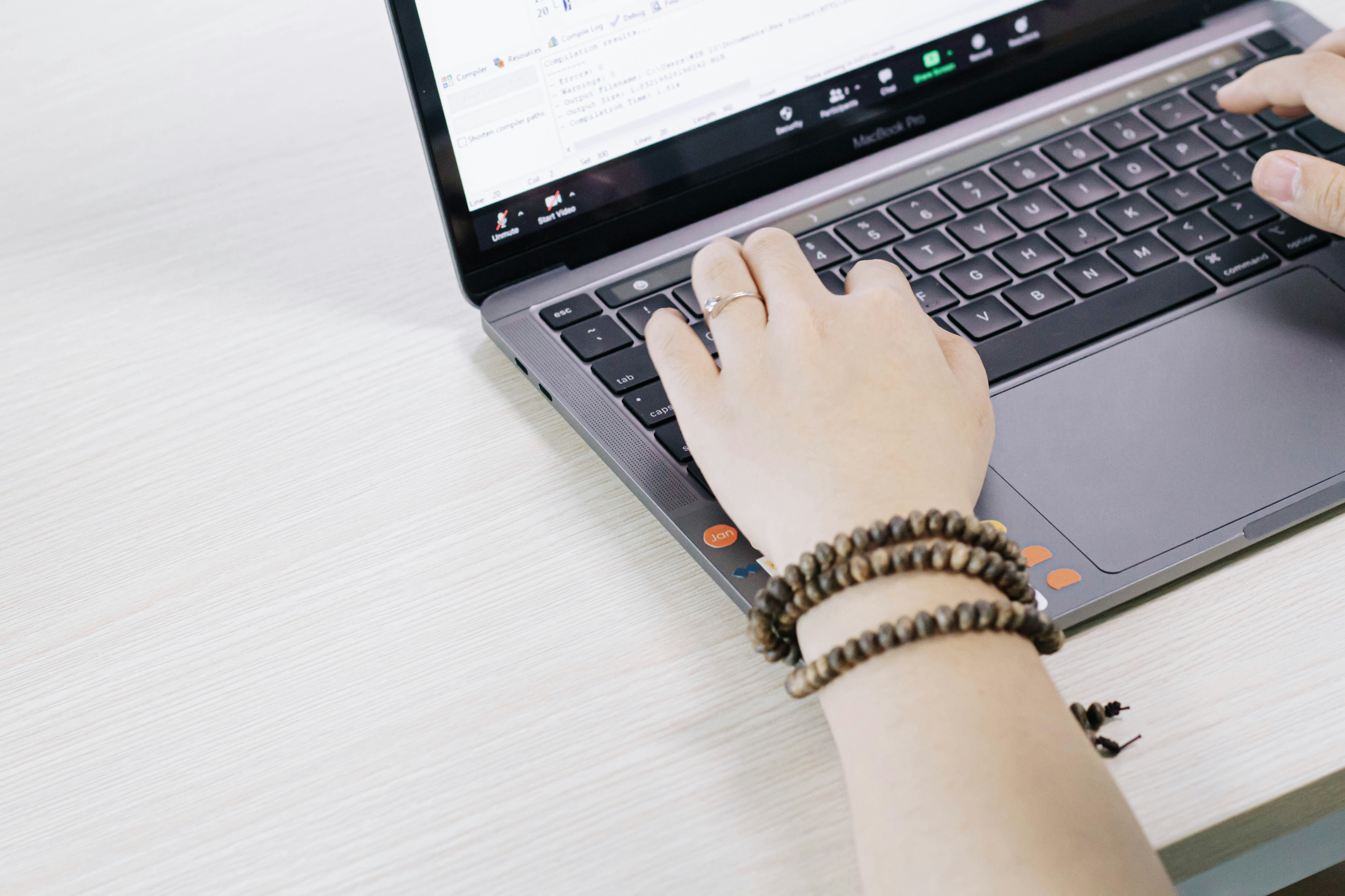 Close-up of someone using a laptop to review records and details online
