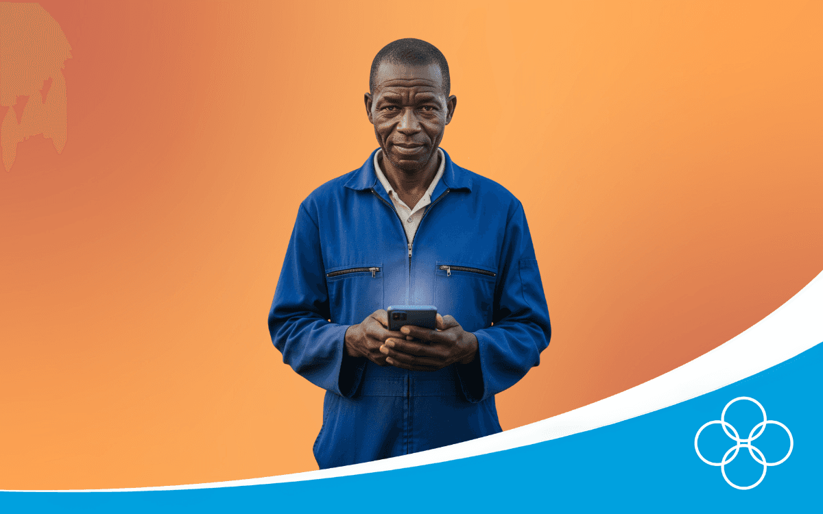 African poultry farmer in a blue overall, holding a phone