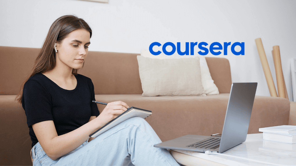 Young professional taking notes while studying an online Coursera certificate on a laptop to upgrade her resume in Canada.