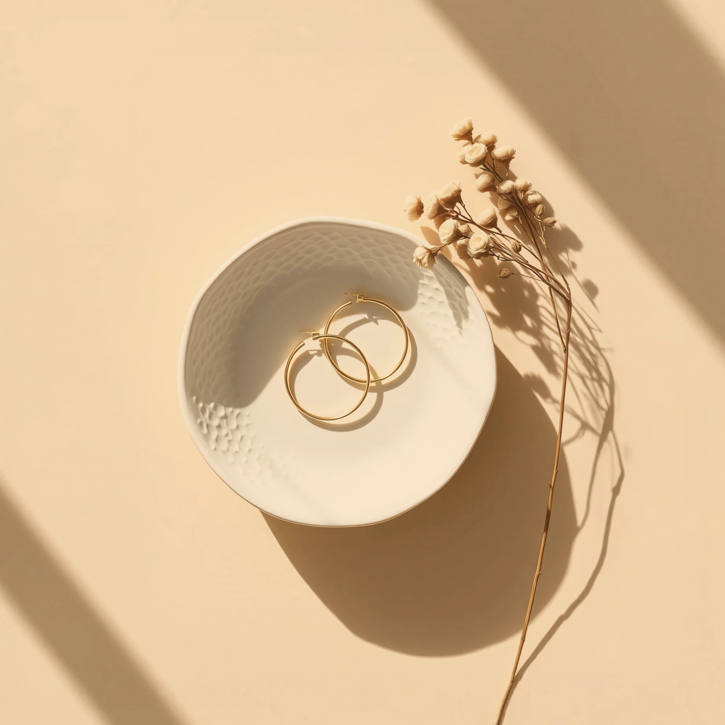 Golden Hoop Earrings in Ceramic Dish