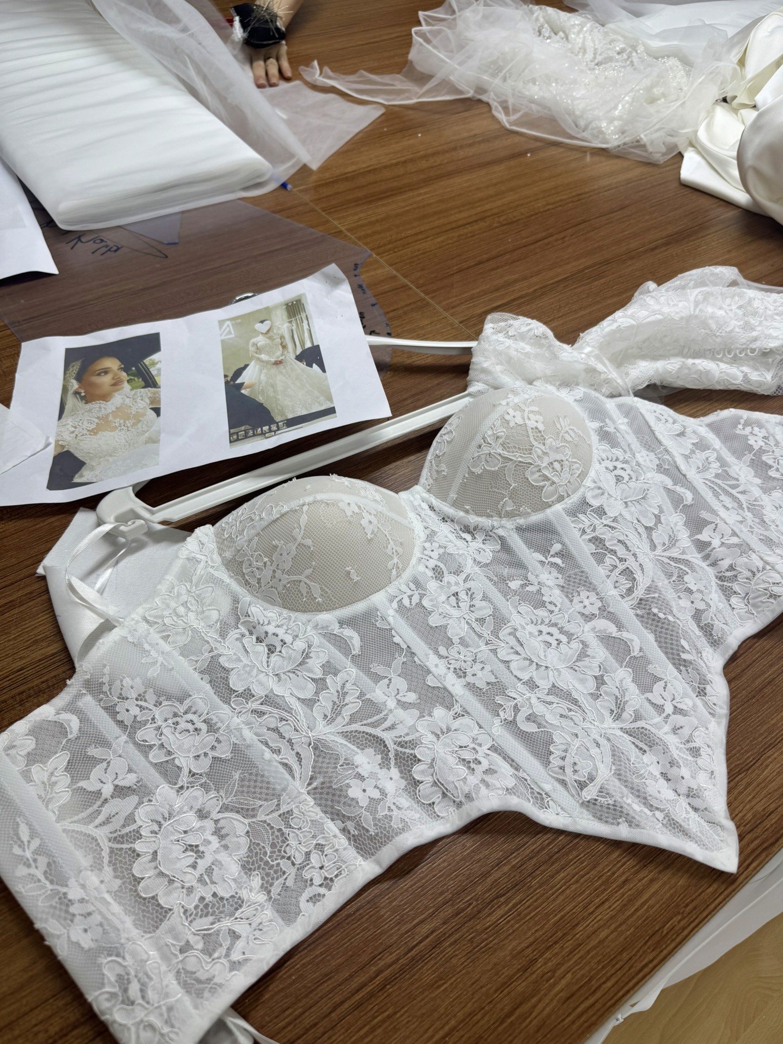 Lucidbride atelier table with lace corset, bridal references and fabric details for The Lucid Index style recommendation experience.