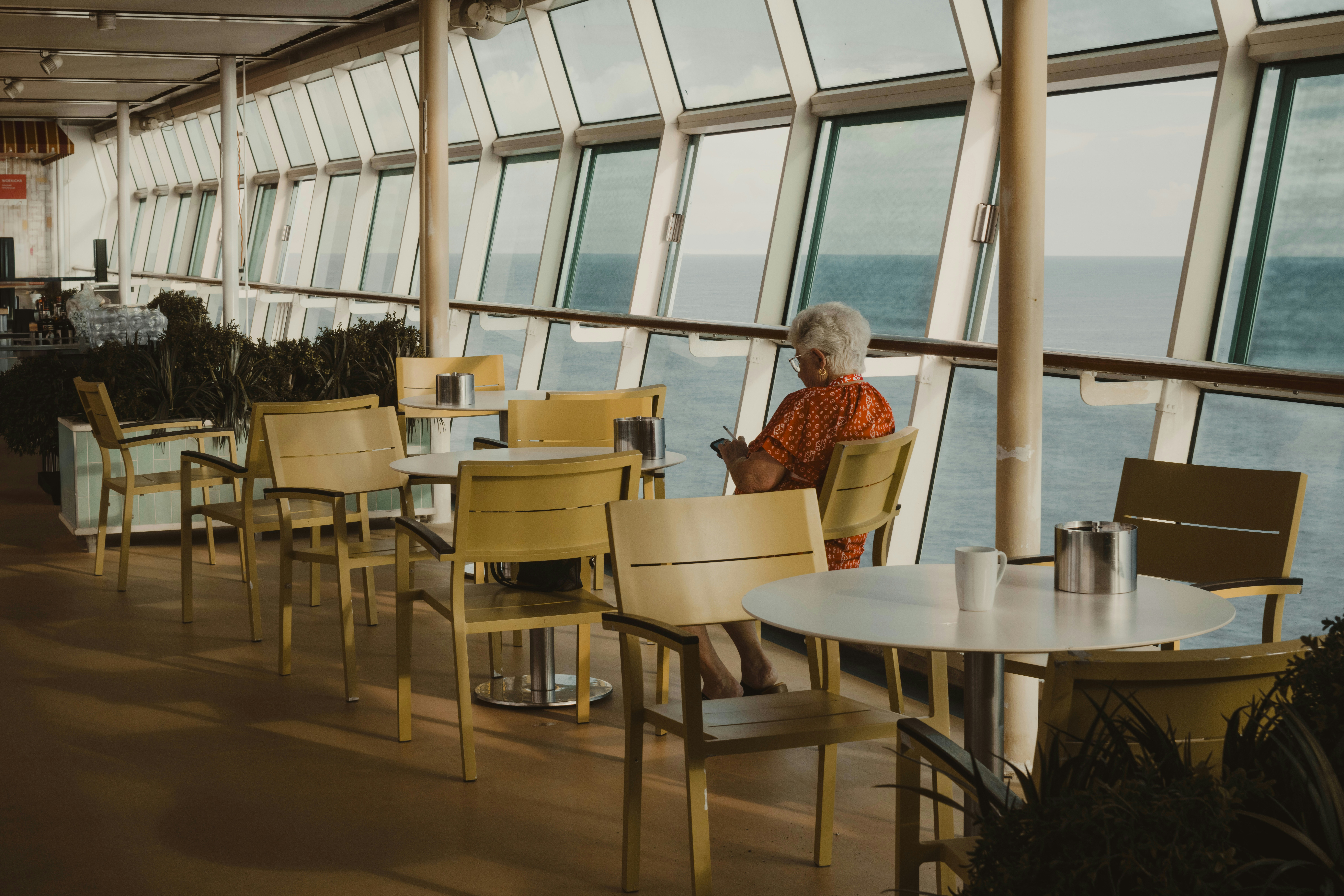 Woman sitting by the window on a cruise ship.