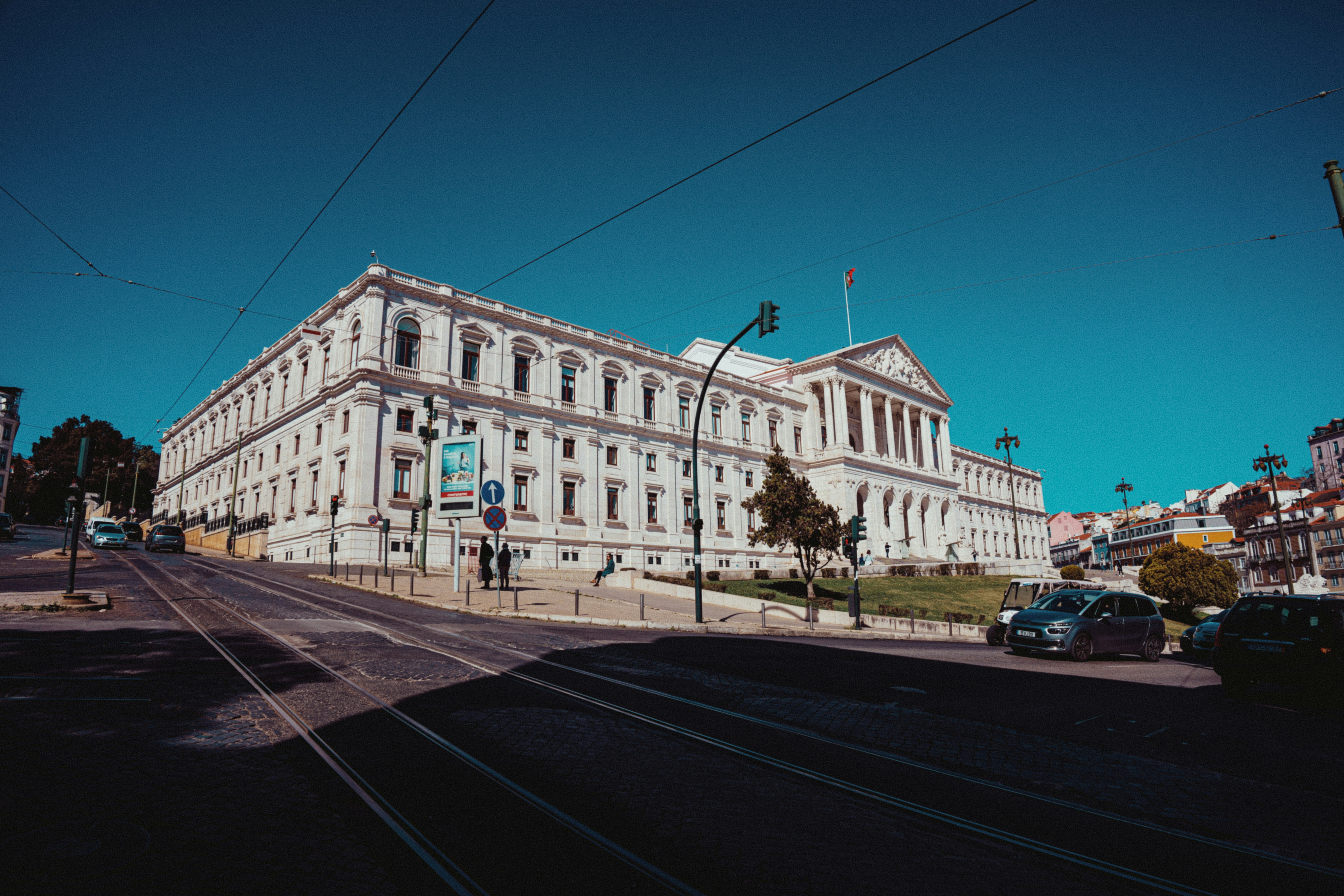 a large white building sitting on the side of a road
