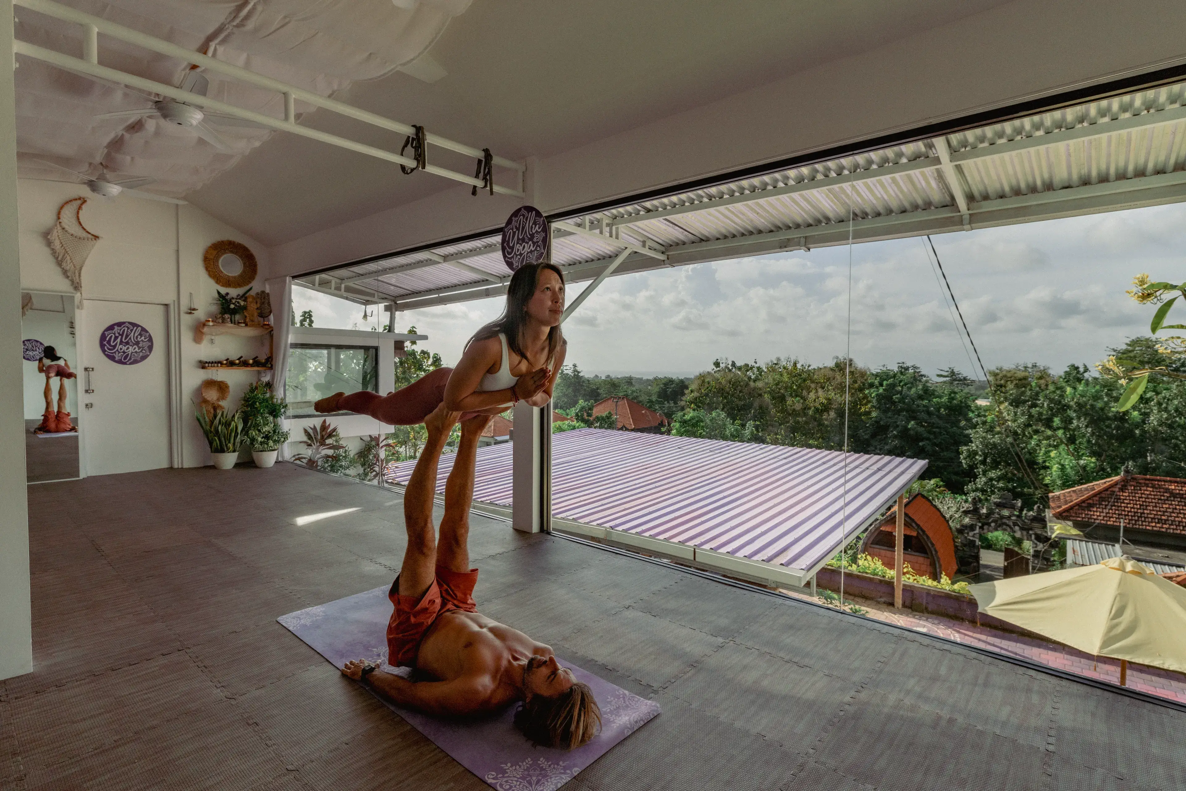Acro yoga workshop demonstrating partner balancing techniques in the multi-style yoga teacher training shala