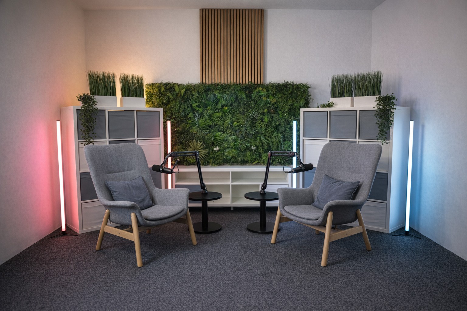 Work meeting where a guy in casual clothing is leading the meeting with other sat down and listening