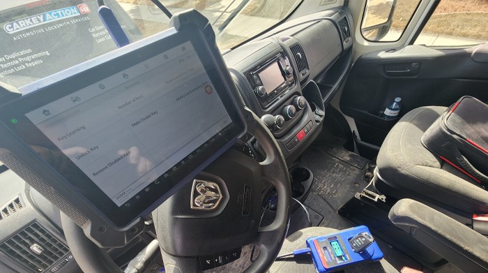 OBD2 car key programming inside a vehicle using professional diagnostic equipment by CarKeyAction automotive locksmith in Calgary.