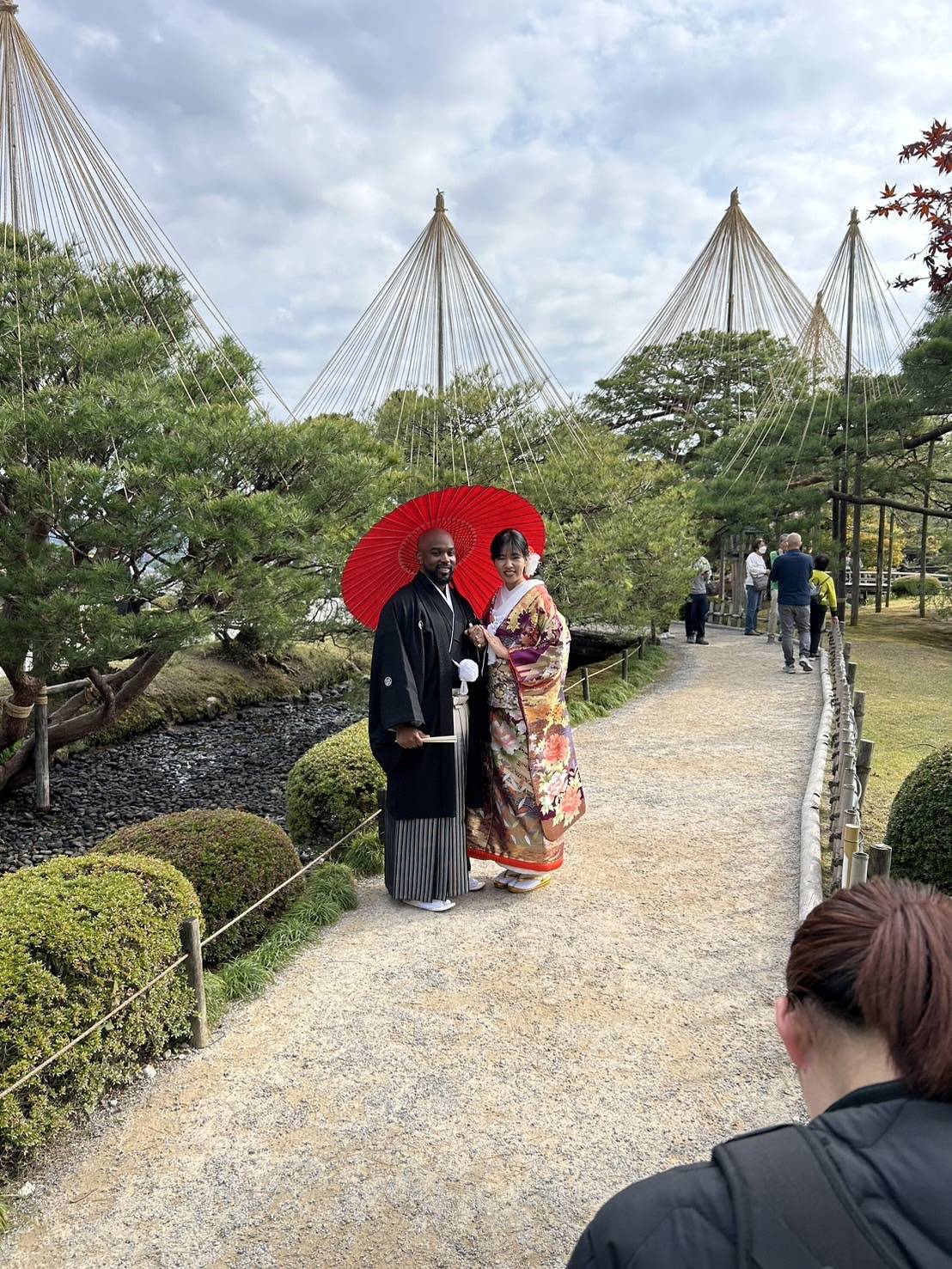 a group of people walking on a sidewalk