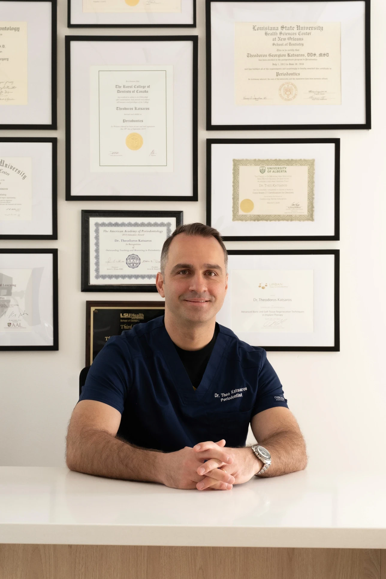 Dr. Theo Katsaros at dental consultation desk making treatment notes at Bloor-Yorkville Periodontics in Toronto, Ontario: the best periodontist and dental implants in Toronto, Ontario