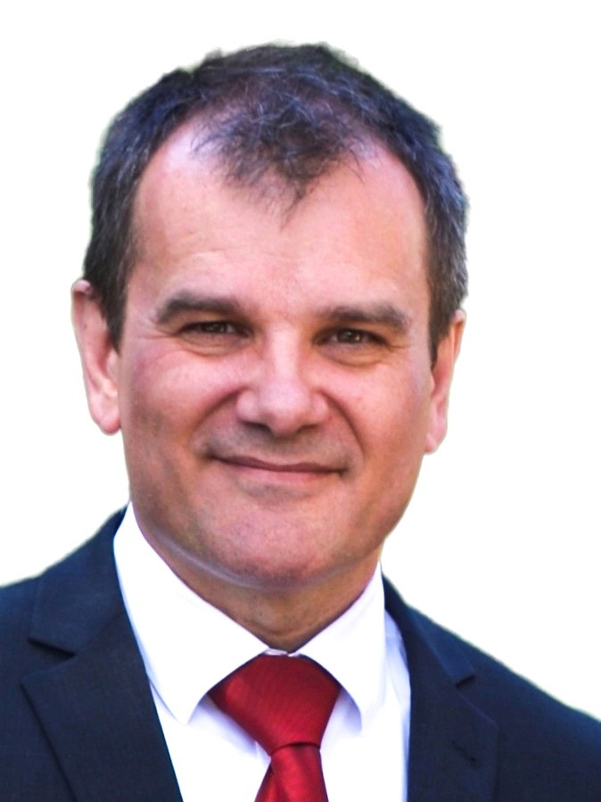 Middle-aged man with short brown hair in a dark blue suit