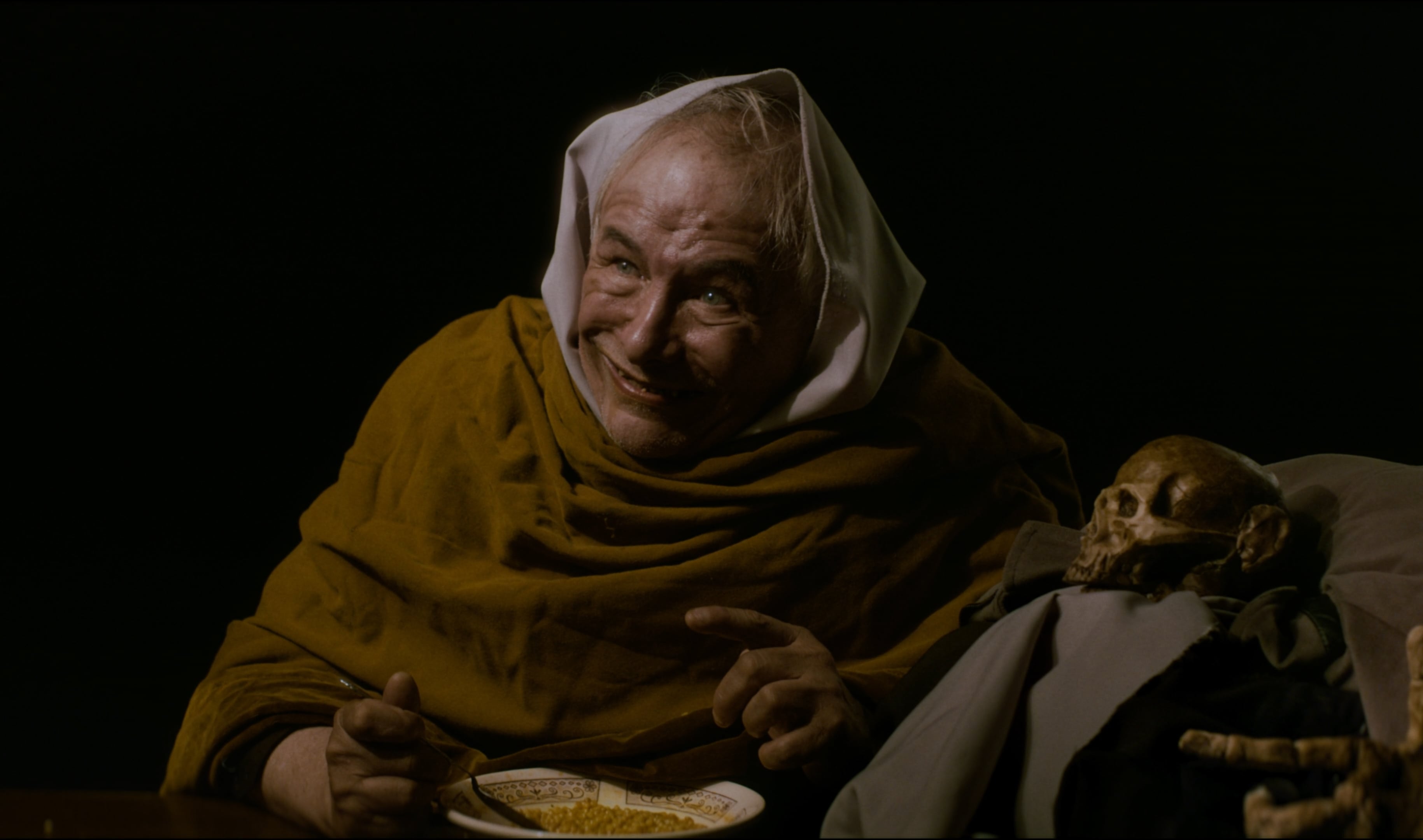 Cinematic recreation of Francisco de Goya's 'Two Old Men Eating Soup' featuring actor Cheko Zaidman. Photographed by Mexico City DP Mauricio Nader using a Blackmagic Pocket 6K G2 paired with a vintage Super Takumar 50mm f1.4 lens to achieve a painterly chiaroscuro aesthetic.