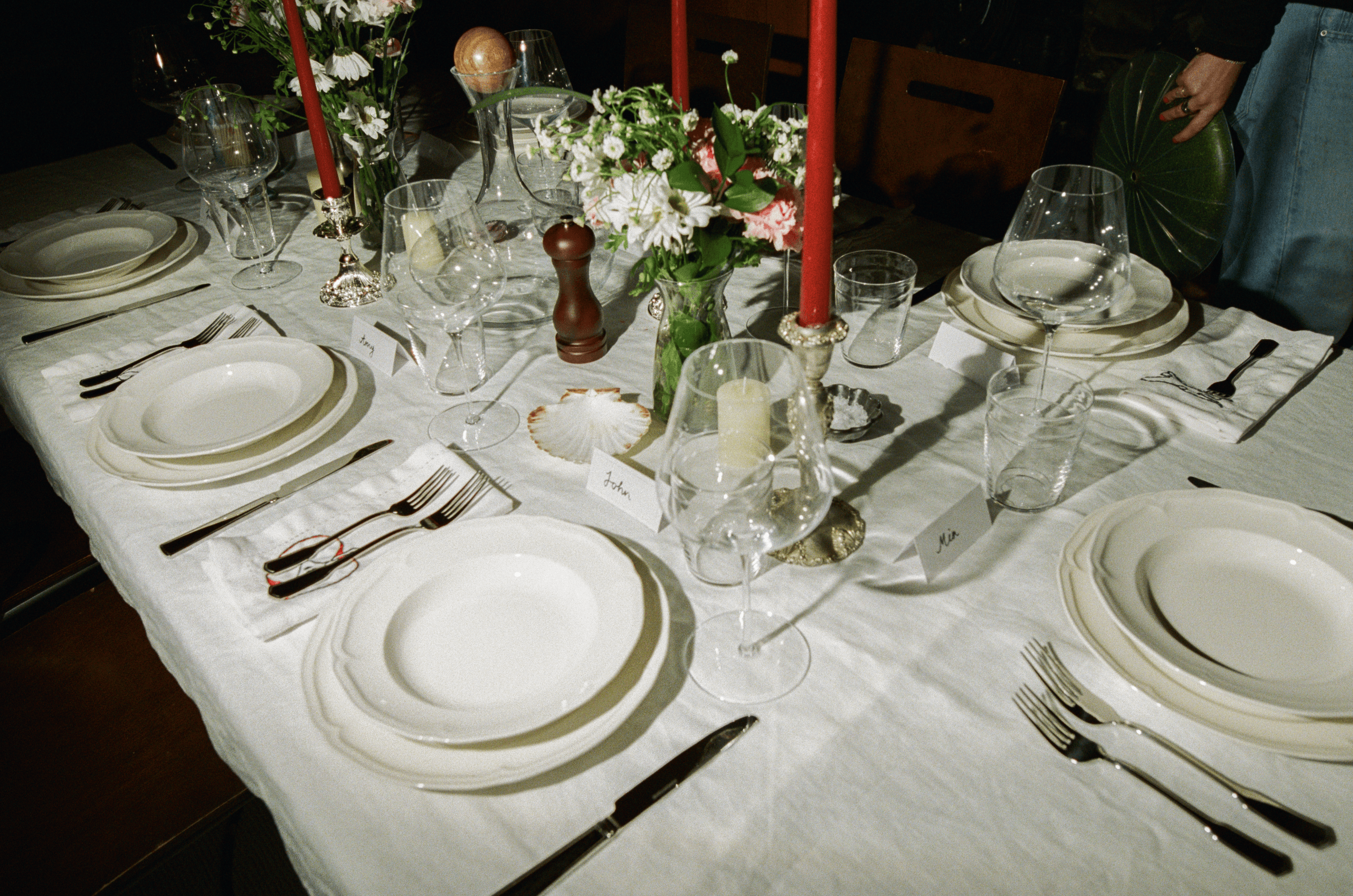 A decorative floral arrangement spills over a table draped in red fabric, creating an elegant atmosphere.