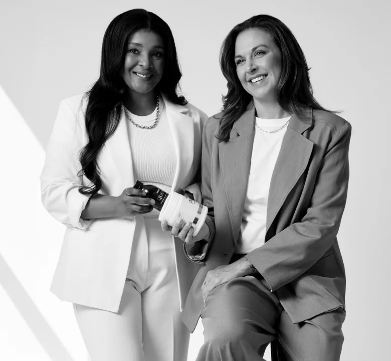 Sēkret founders Roz and Zola with a tub of Pure and a bottle of Queen, in black and white
