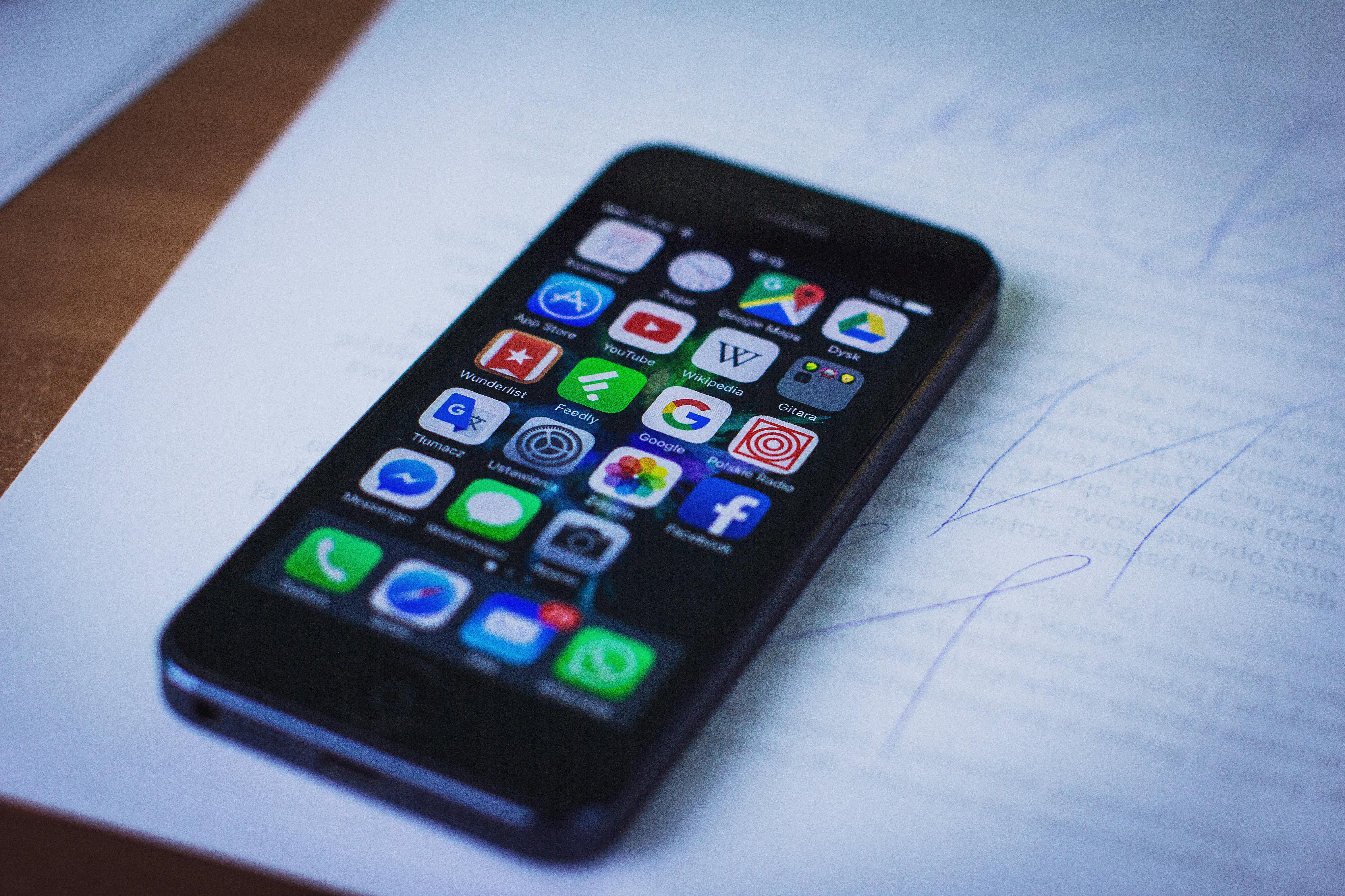 Iphone featuring differnt apps, including wikipedia