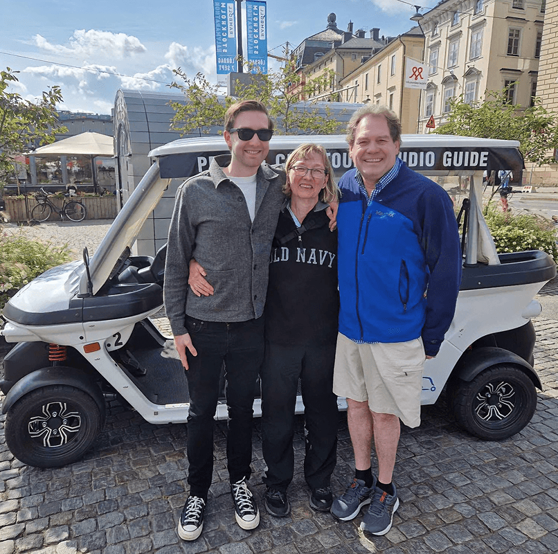 Tourists exploring Stockholm during private electric sightseeing cart tour