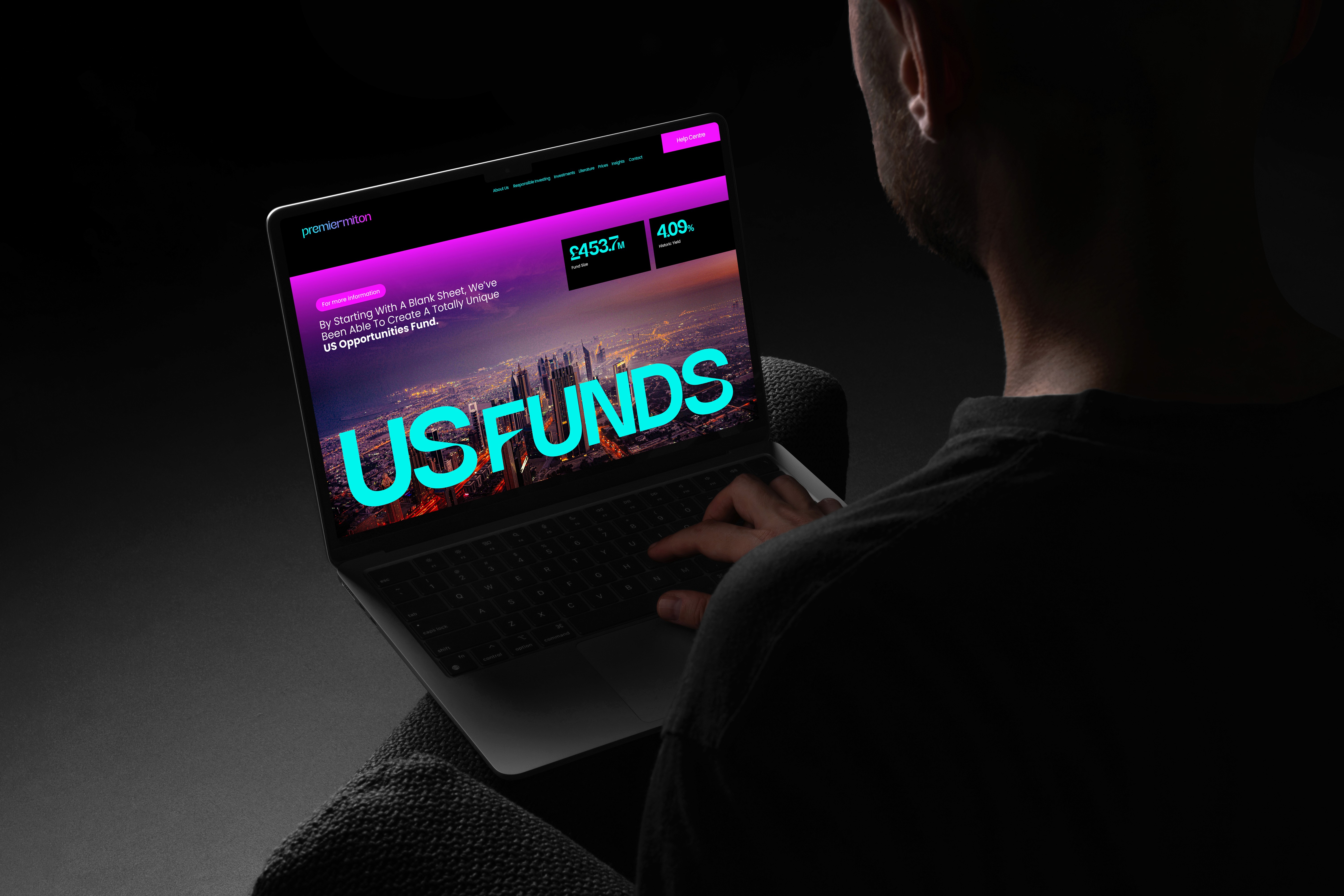 Man holing iPad showcasing Premier Miton web design concept screen.