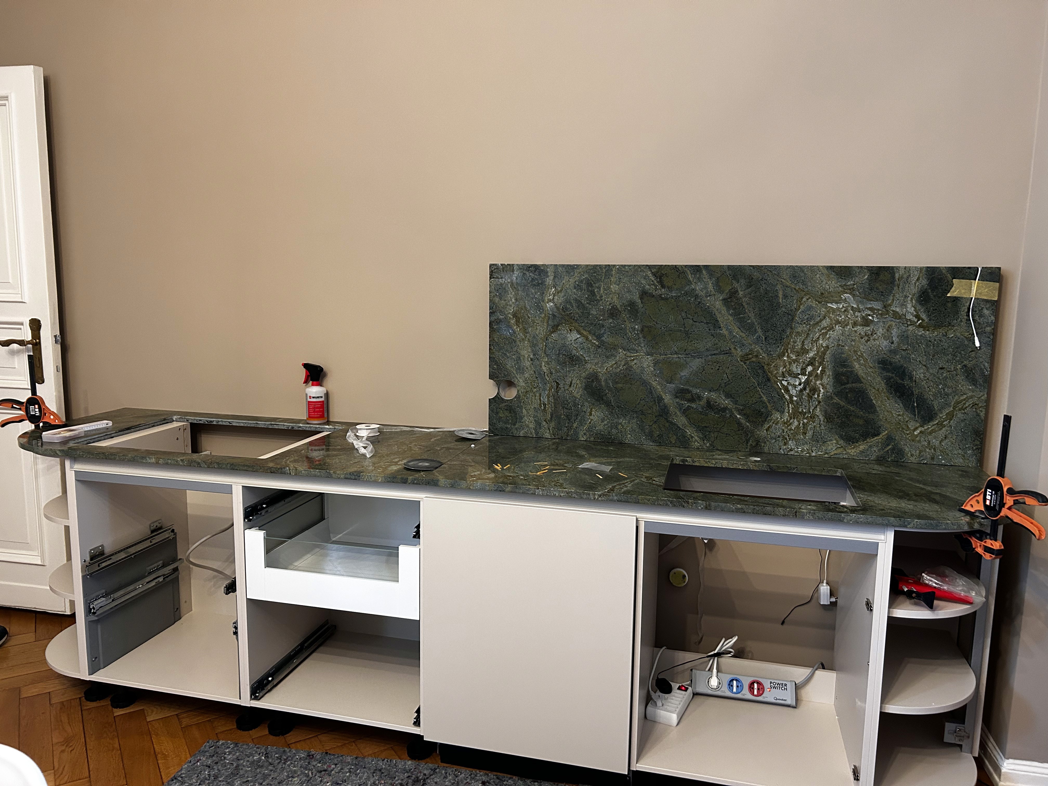 Kitchen with a green stone backsplash.