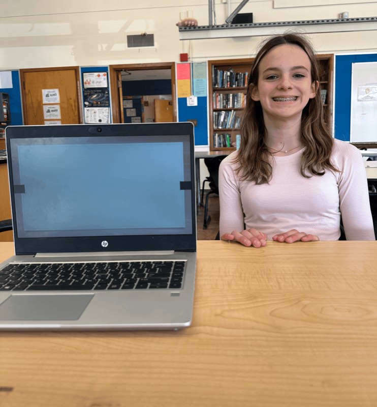 Sylvie at school opting out of using a school-issued laptop