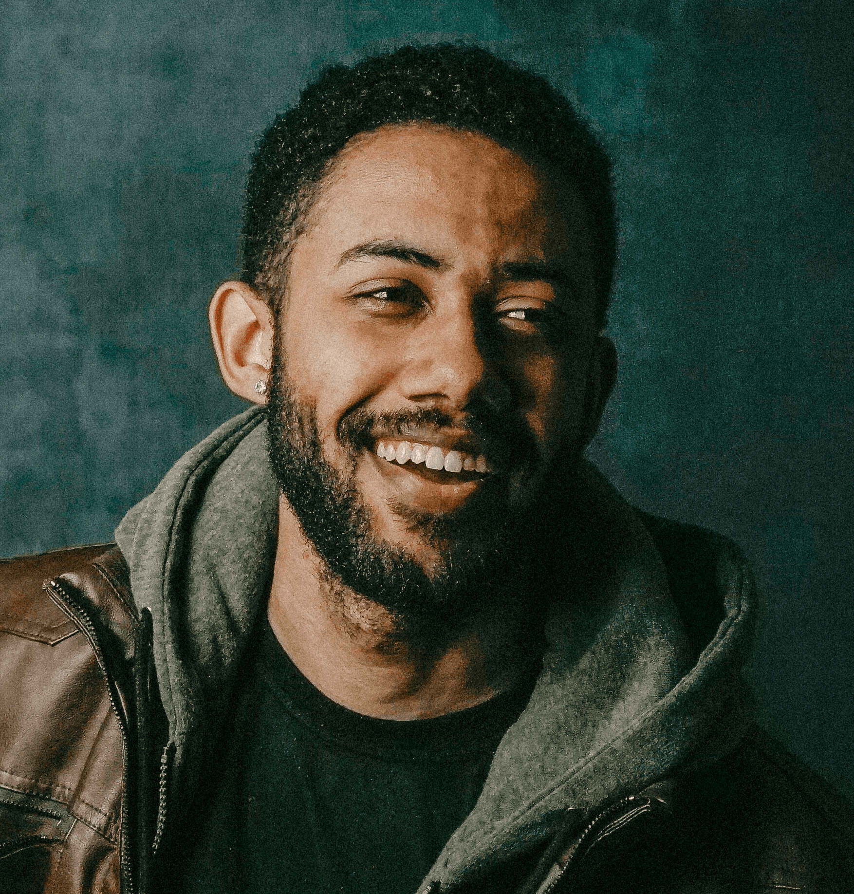 man in black leather jacket playing blue electric guitar