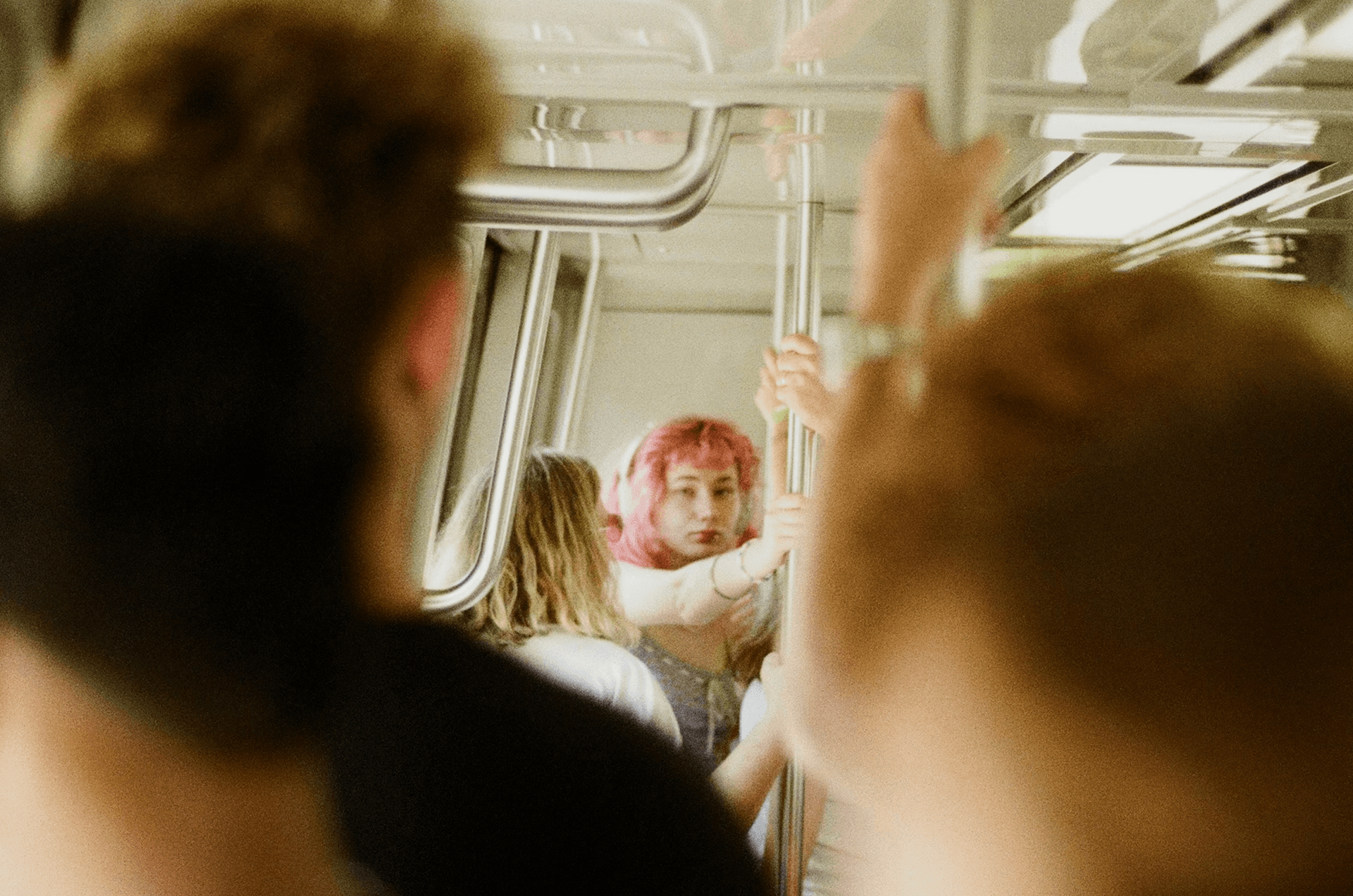 A crowded train scene with a pink-haired person at the center, symbolizing the best PhantomBuster alternatives for B2B outreach in 2026.