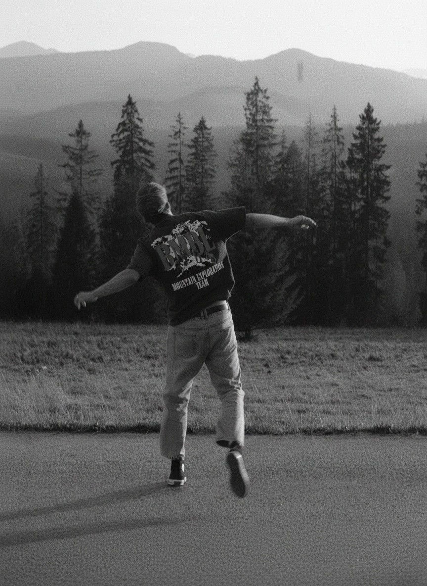 Beach scene; lifted tee reveals bikini and graphic.