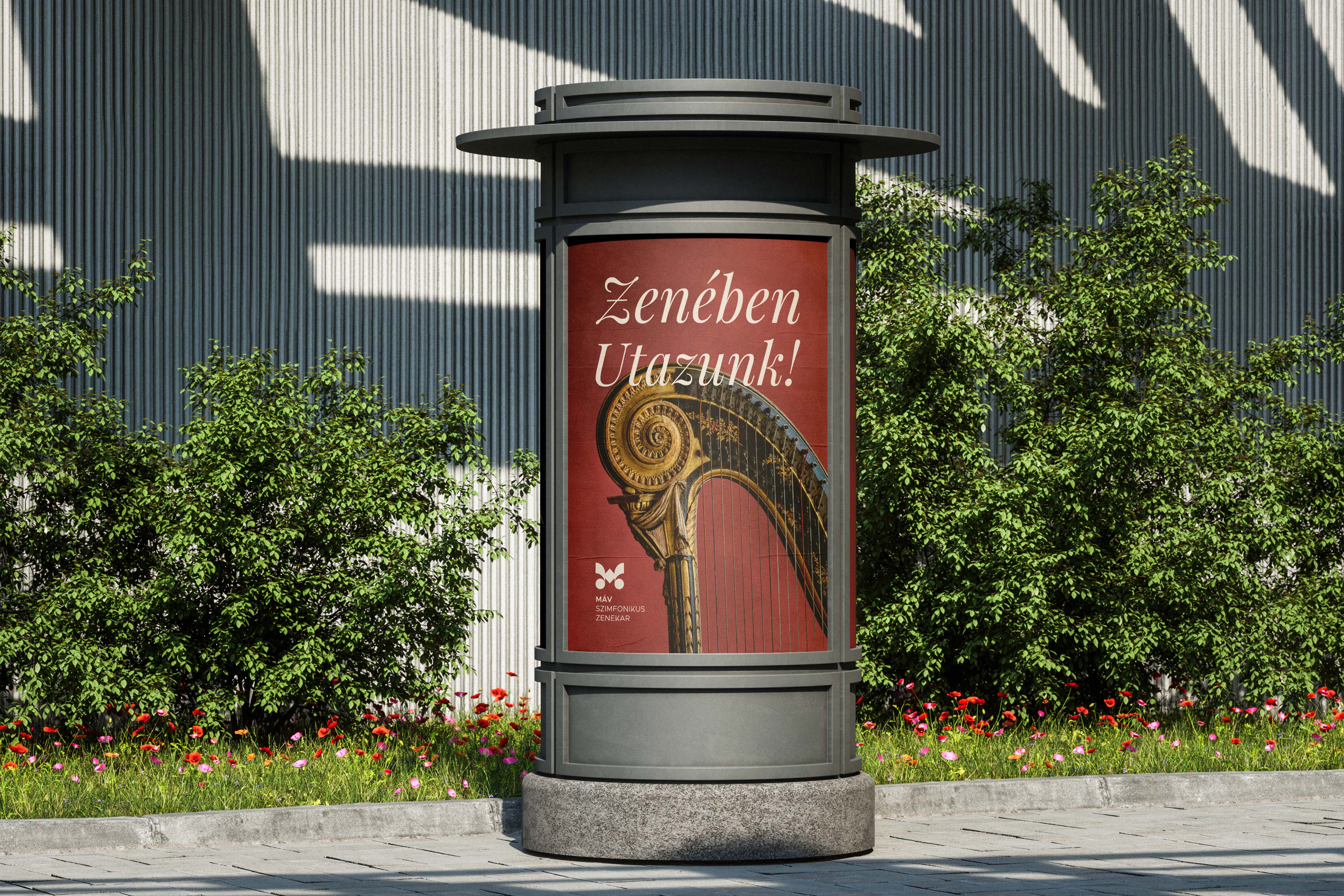 Round citylight column poster with V2 logo, ornate harp close-up and headline in a green urban setting - MÁV Symphony Orchestra, a symphony orchestra brand identity.
