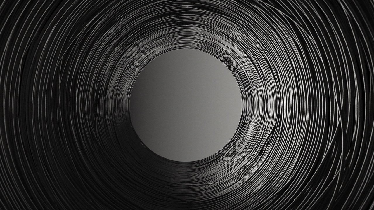 Abstract macro view of curved black 3D printing filament.