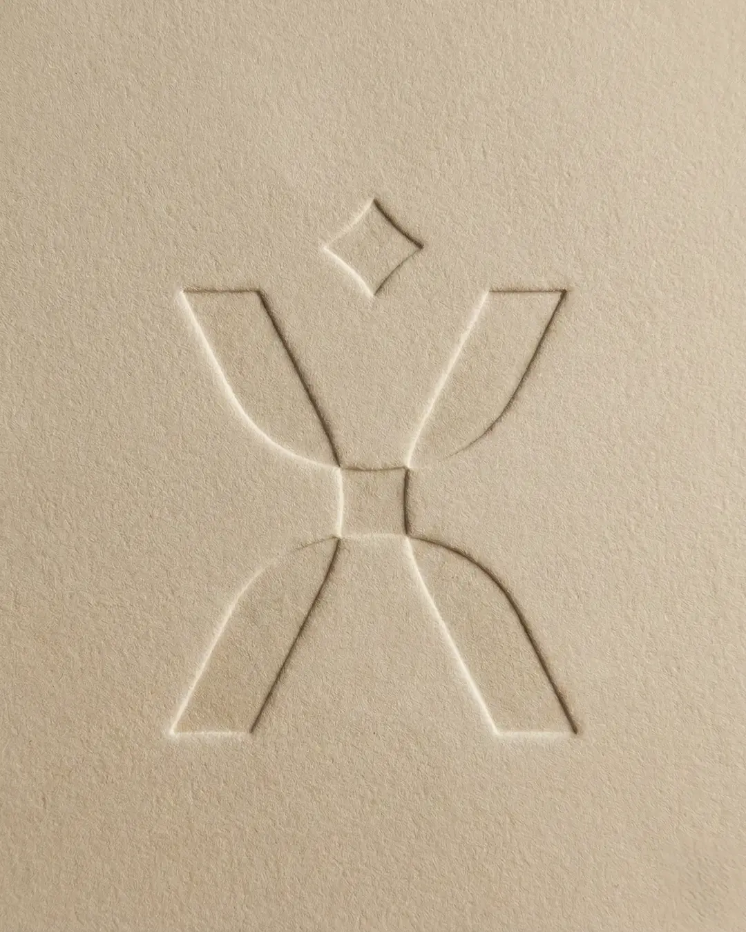 Pixid logomark — embossed X human figure icon on kraft paper, logo design for HR tech brand