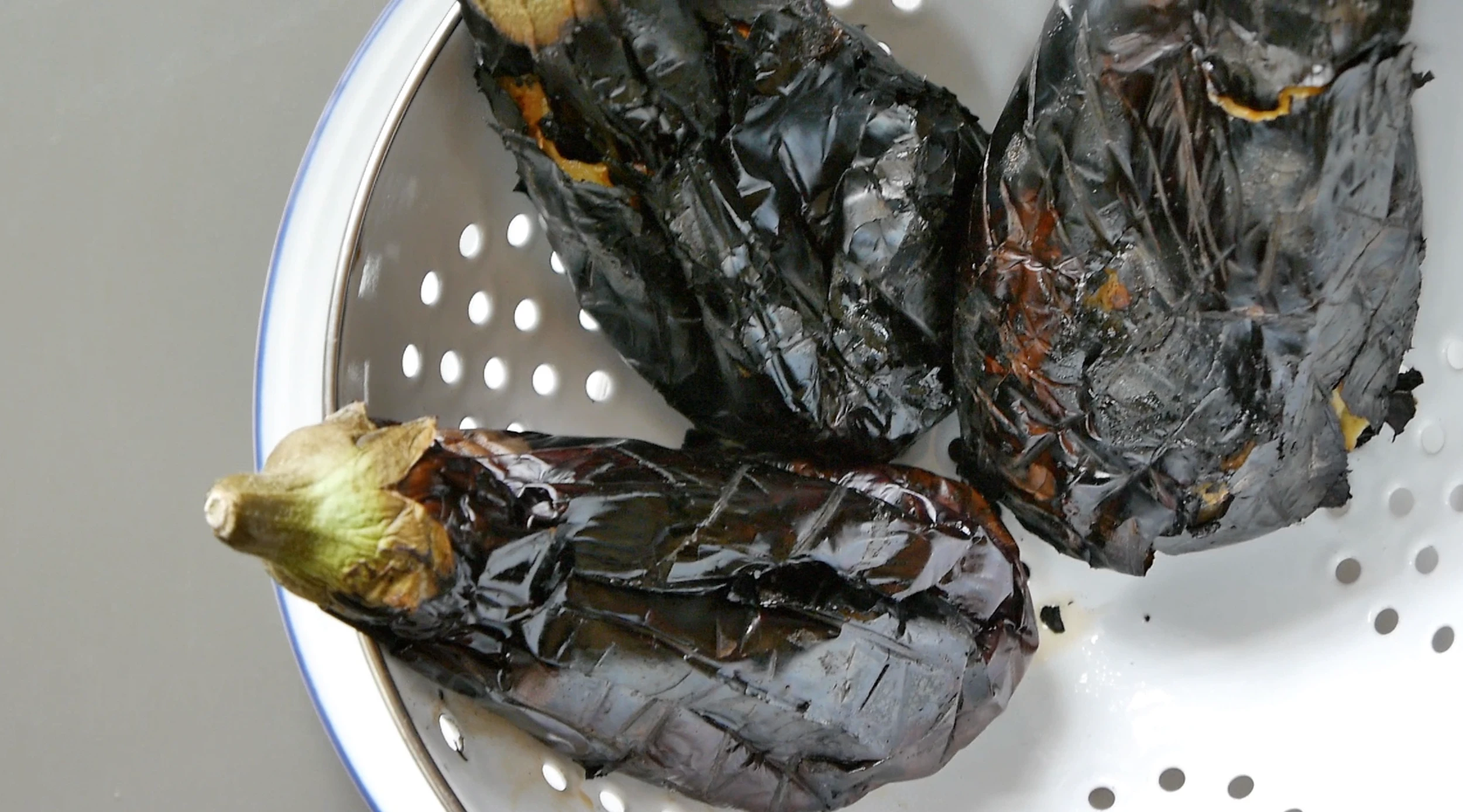 Smoked aubergine in a colander