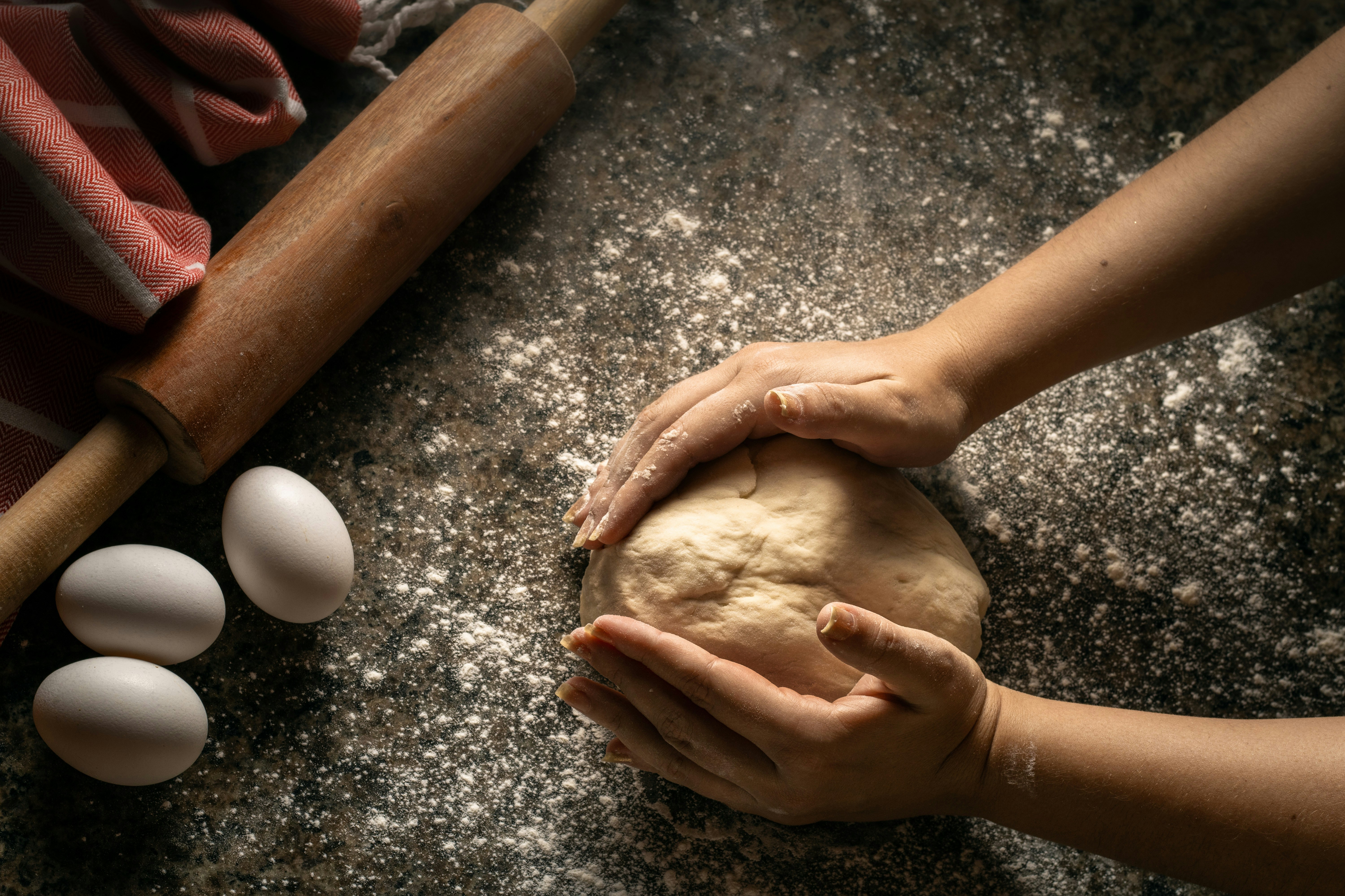 Human hands making dough