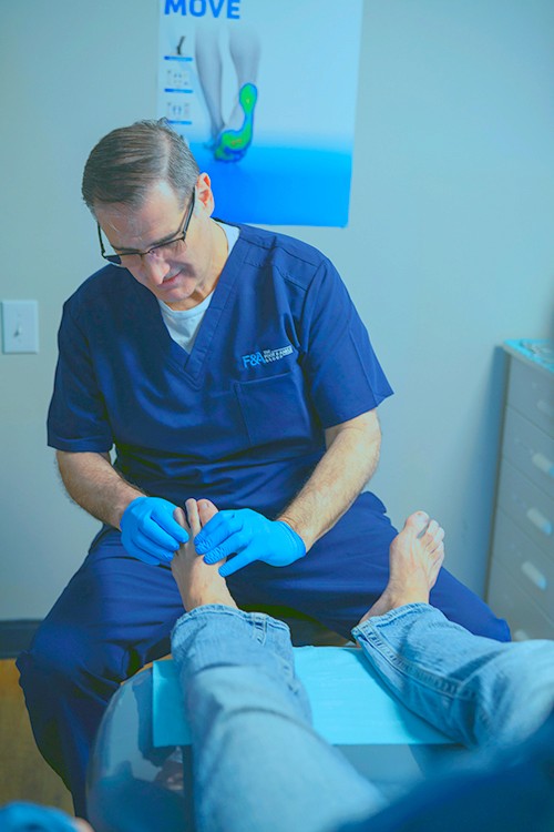 A doctor checking the patient feet
