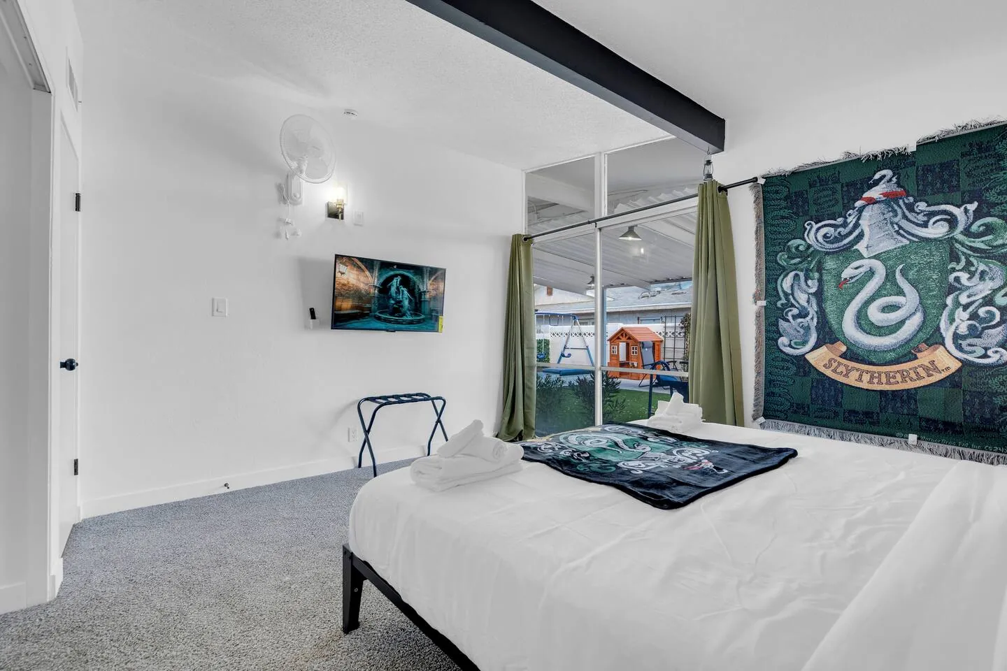 Green-themed king bedroom with a wall-mounted TV, Wizard’s Dream in North Las Vegas