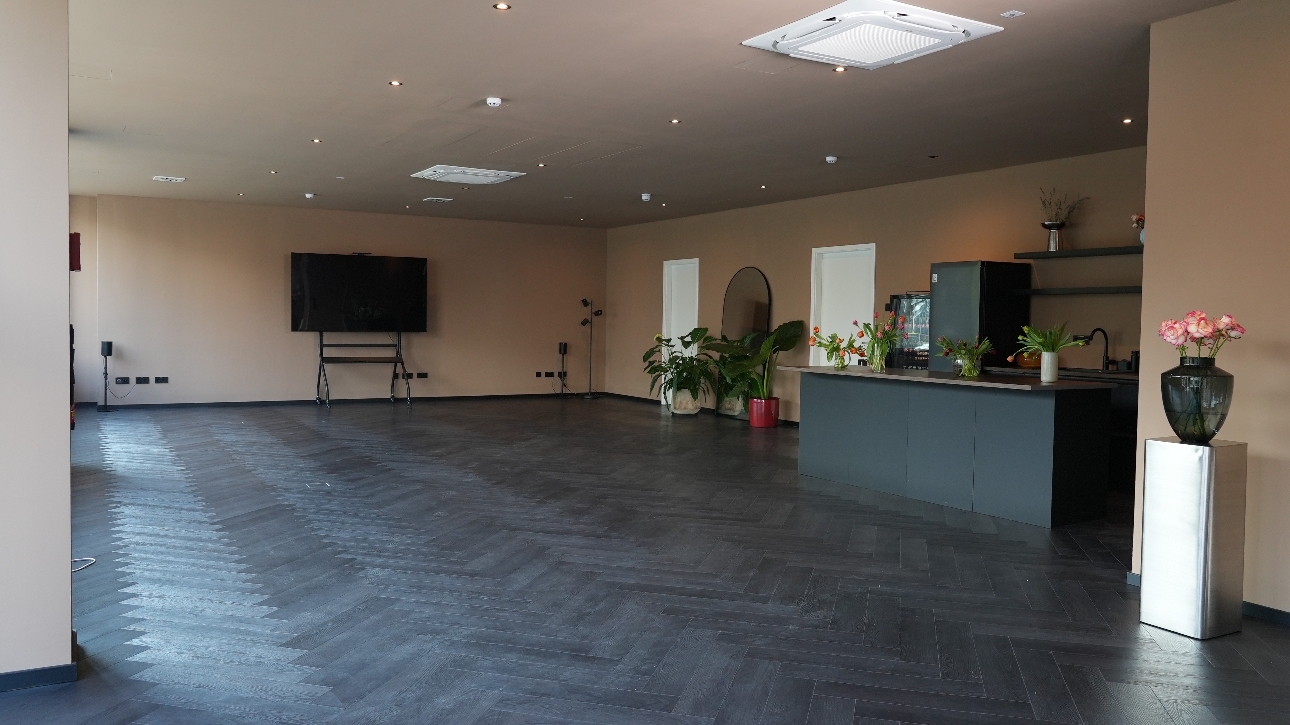 Woman typing on laptop at wooden table with breakfast.
