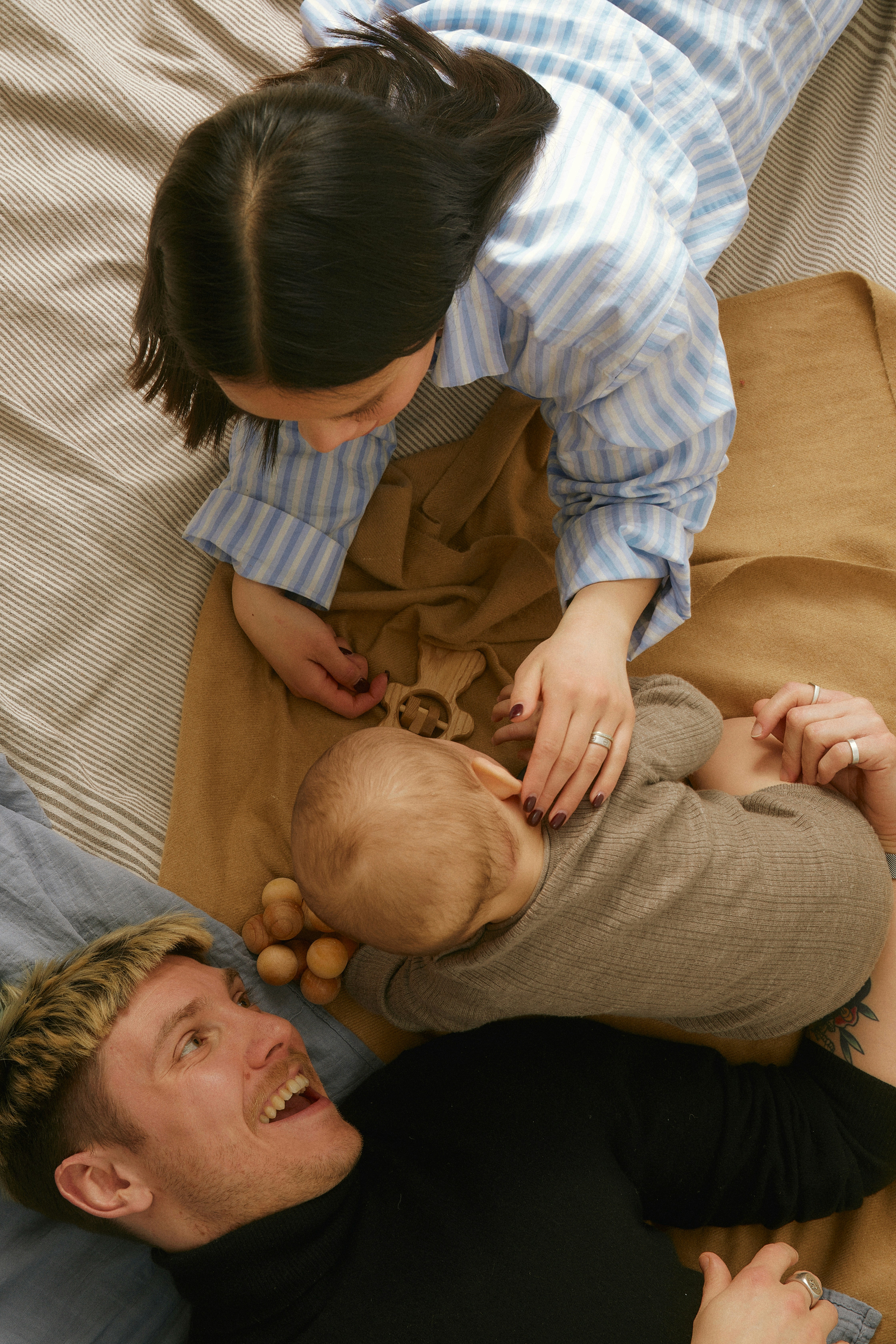 Parent and child sharing a joyful moment together on the floor, capturing the warmth of everyday family life