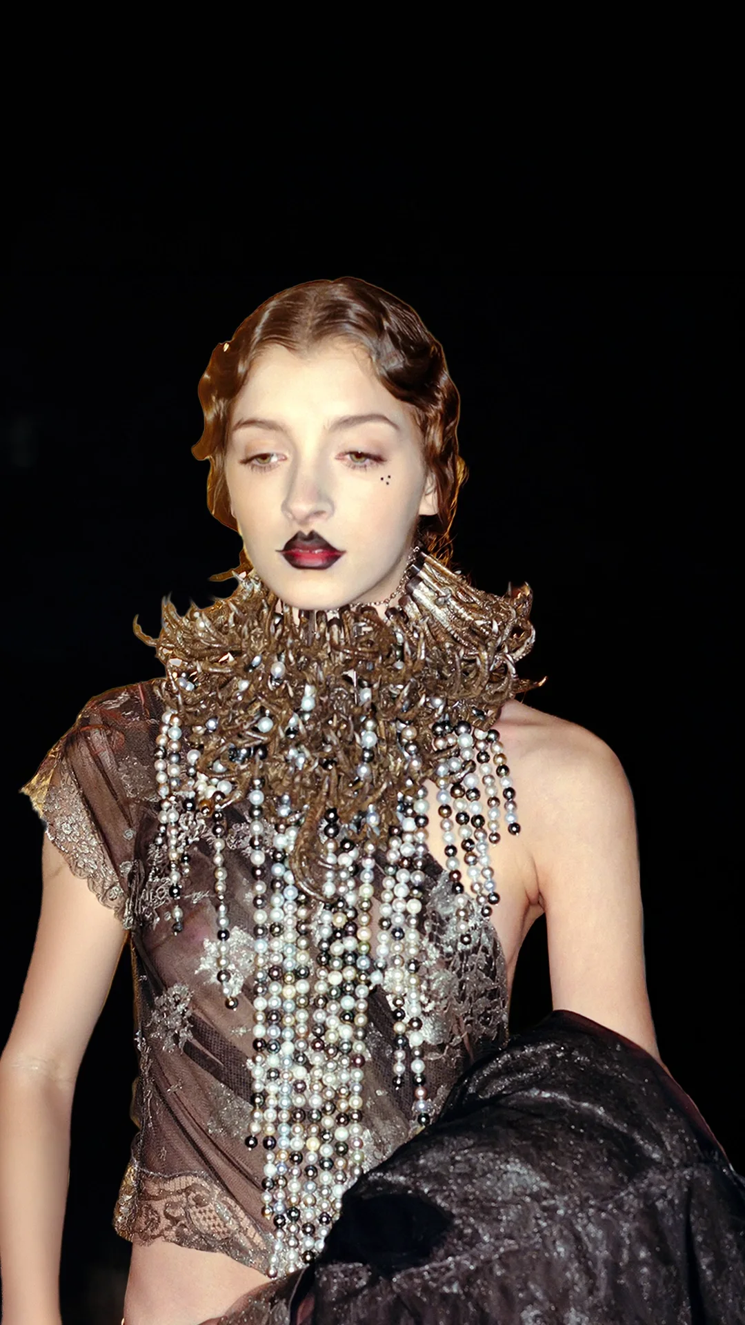 Runway model showcasing a heavy, avant-garde interlocking silver pheasant claw necklace designed by Shaun Leane for Alexander McQueen.