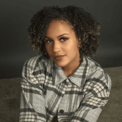 man in green zip up jacket smiling