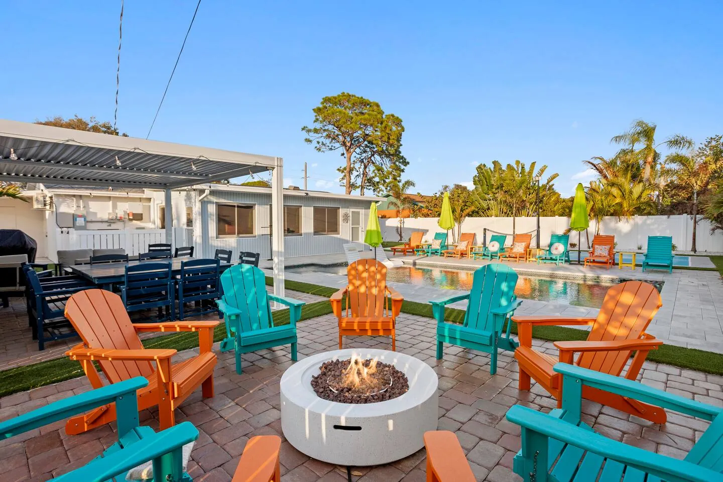 Fire pit and Adirondack chairs with pavilion and by day at Pickleball Resort, Bradenton, Florida