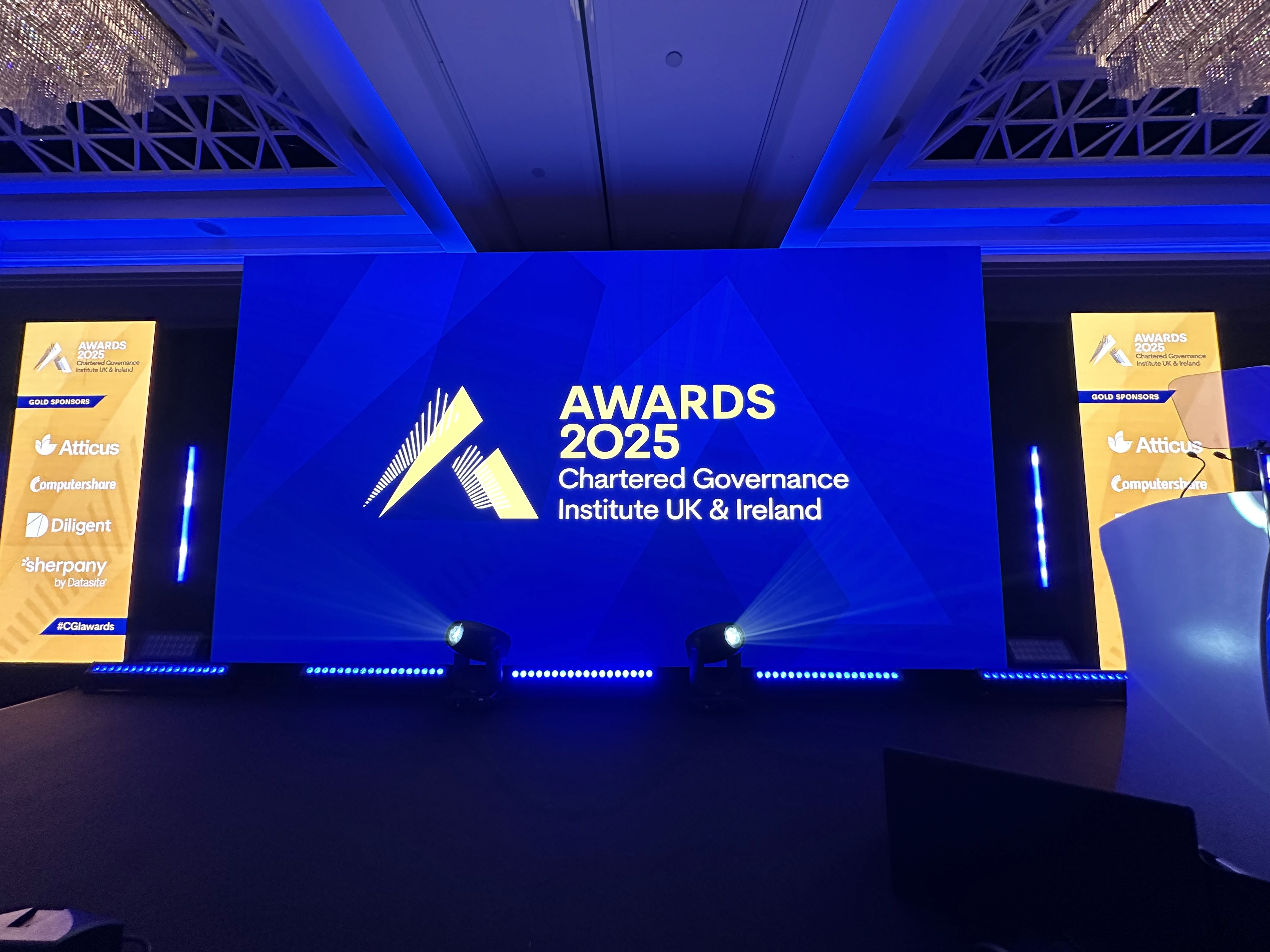 Front view of the CGI Awards 2025 stage featuring a large central LED wall and four vertical sponsor displays.