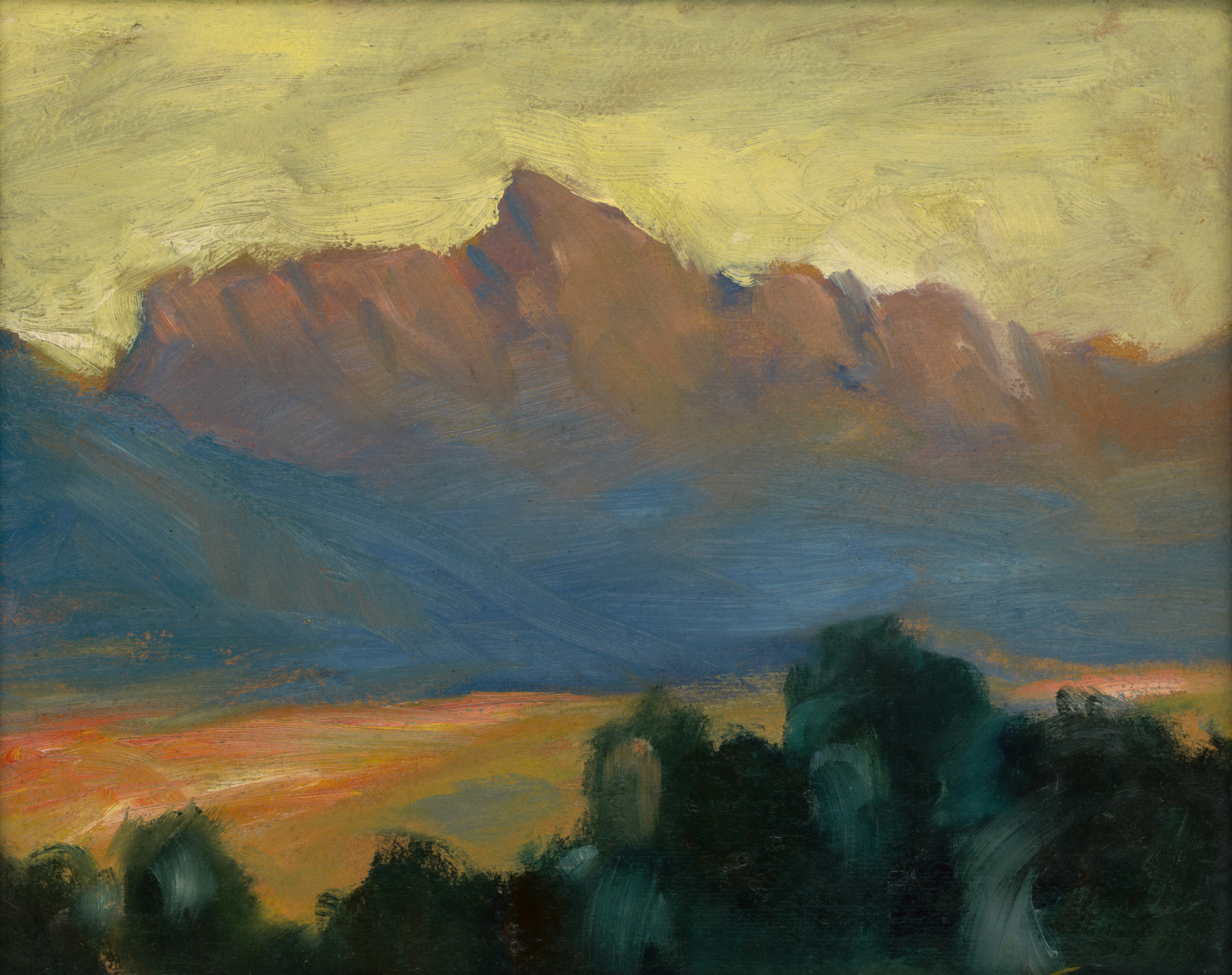 Mountain range at sunset with warm glow