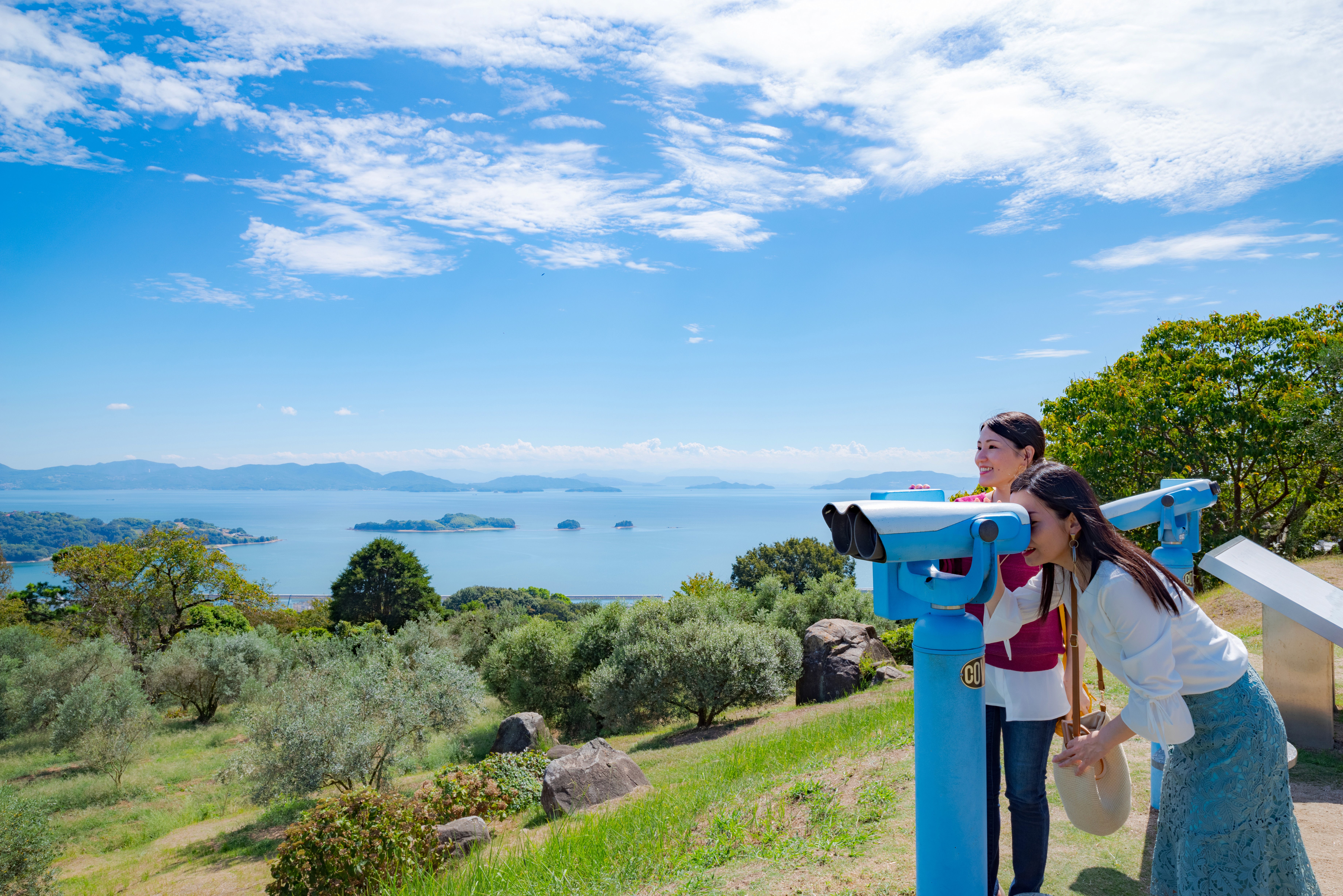 Looking through a telescope to see the other islands in the area