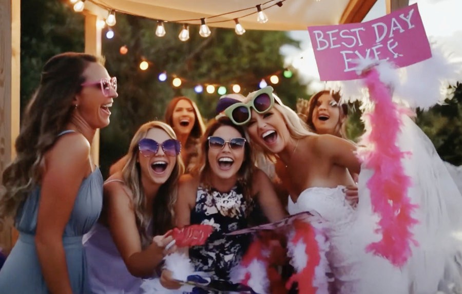 Guests holding props at a modern photo booth experience