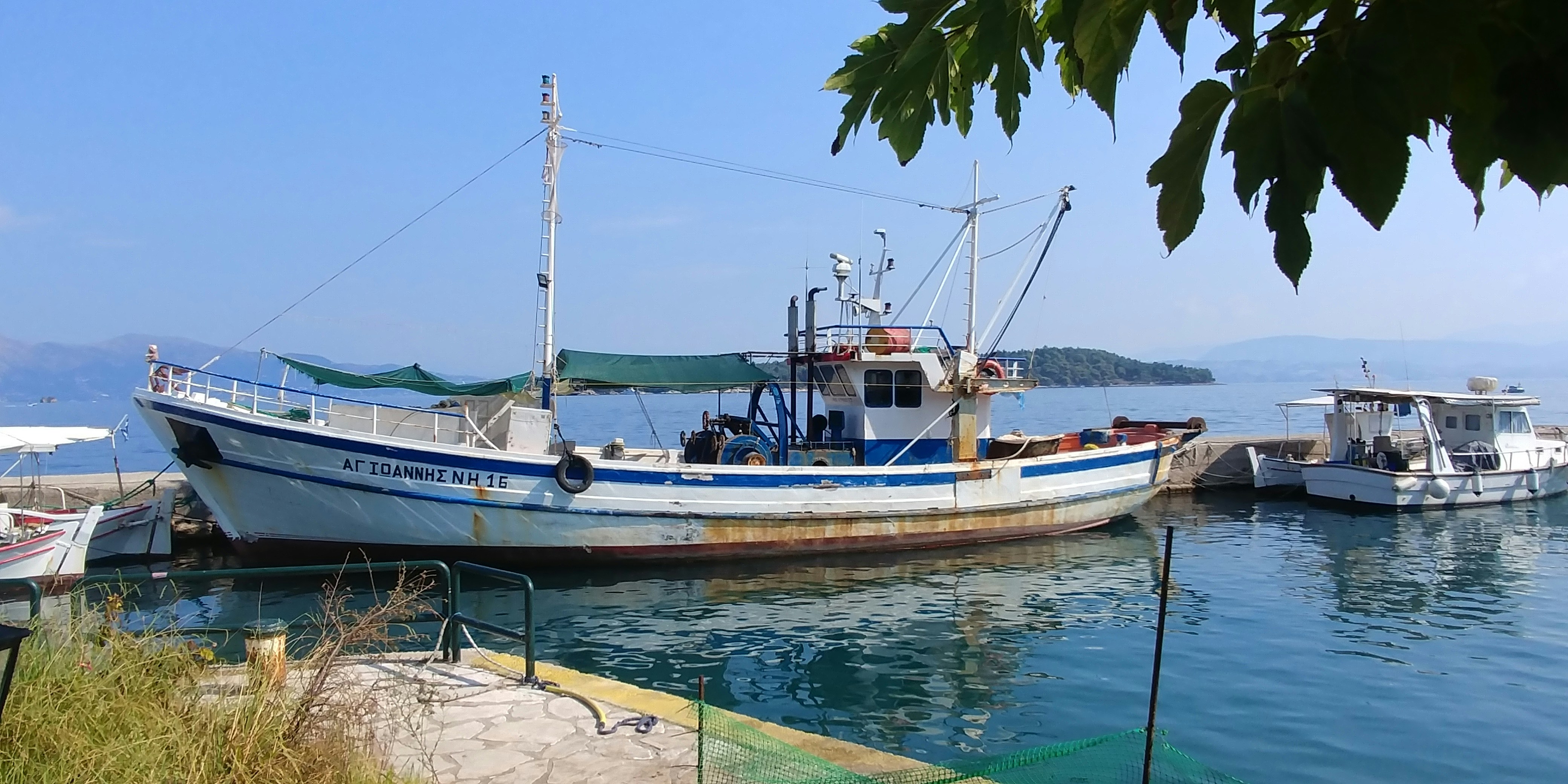 Small boats in a blue-water harbour on Corfu
