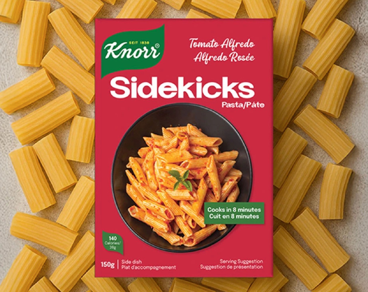 A close-up of a hand wearing multiple decorative rings against a blue background.